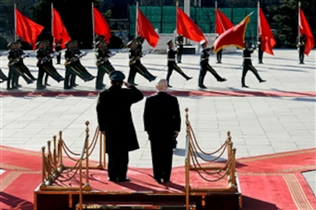 Chinese Minister of Defense Liang Guanglie and U.S. Defense Secretary Robert M. Gates observe as the People's LIberation Army as they honor Gates' visit to the ministry of Defense in Beijing, Jan. 10, 2011. Gates met with Chinese Defense Minister Liang Guanglie and his staff at the ministry and held a press conference there.