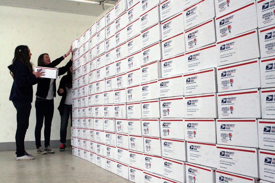 Young women from the non-profit National Charity League stack care packages filled with combat boot socks, snacks and other coveted items during the 4th Annual Operation Valentine at Camp San Mateo, Jan. 9. A total of 1,100 mothers and daughters from the NCL created 2,400 care packages and wrote Valentine’s Day cards for deployed Marines and sailors. The care packages will be sent to three deployed battalions from the 1st Marine Division and female engagement team members.