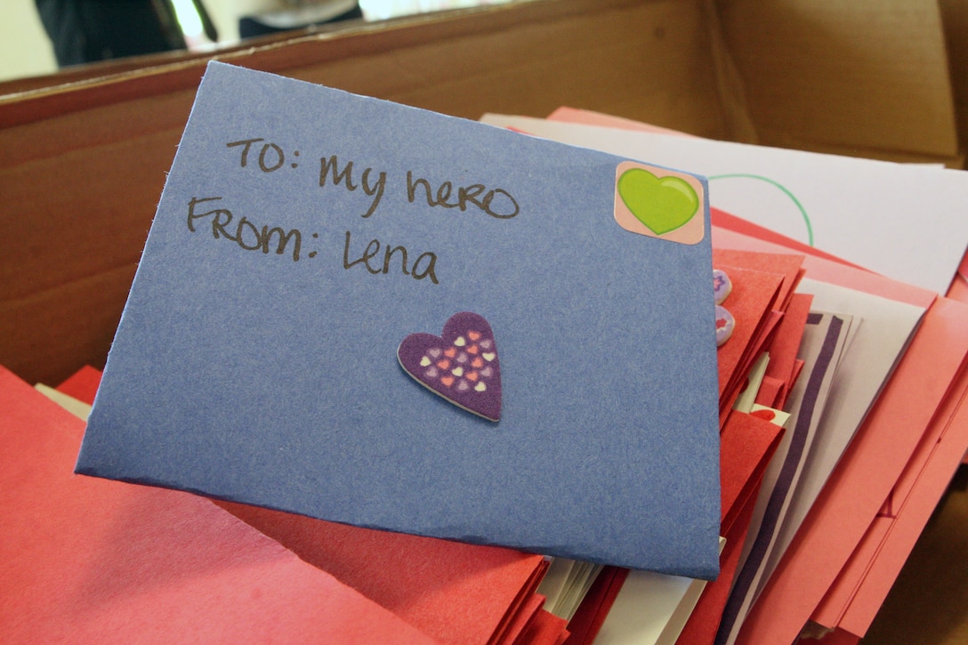 A Valentine’s Day card written by a young woman with the non-profit National Charity League sits on top off numerous other cards during the 4th Annual Operation Valentine at Camp San Mateo, Jan. 9. A total of 1,100 mothers and daughters from the NCL created 2,400 care packages and wrote Valentine’s Day cards for deployed Marines and sailors. The care packages will be sent to three deployed battalions from the 1st Marine Division and female engagement team members.