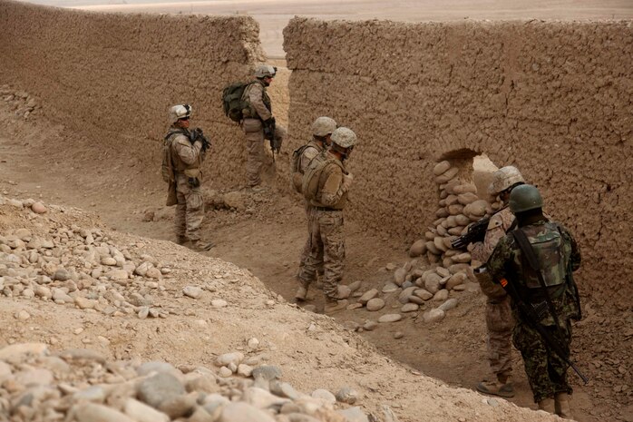 U.S. Marines with Lima Company, 3rd Battalion, 5th Marine Regiment conduct a census patrol in Sangin, Afghanistan, Jan. 10, 2011. The Marines conduct patrols to suppress enemy activity and gain the trust of the people. The battalion, assigned to Regimental Combat Team 2, conducted counterinsurgency operations in partnership with the International Security Assistance Force.