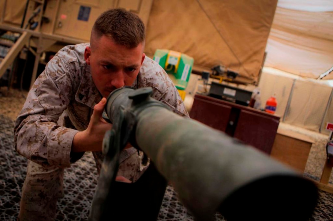 Cpl. Joseph Nordone, 21, electro-optical ordnance repairman, Support Company, Combat Logistics Battalion 3, 1st Marine Logistics Group (Forward), inspects a M1A1 Collimator aboard Camp Dwyer, Afghanistan, Jan. 10. The Collimator is a device used to assist artillery units in maintaining accurate fires when firing missions.