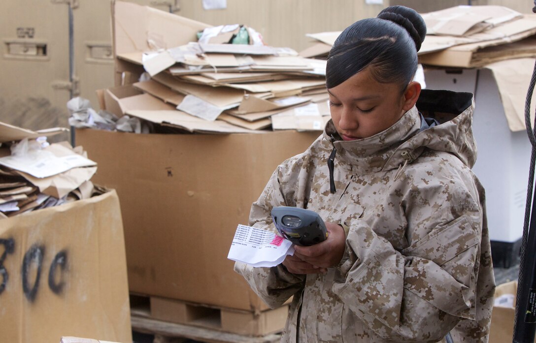 Lance Cpl. Andrea Bernai, warehouse supply clerk, Supply Company, Combat Logistics Regiment 15 (Forward), 1st Marine Logistics Group (Forward), enters information into a symbol scanner, a device used to help log and track supplies on the storage lot at Camp Leatherneck, Afghanistan, Jan. 10. Fewer than 90 Marines are responsible for manually filling orders to provide supplies including personal gear, truck parts and building materials to Marines operating in Nimruz and Helmand provinces. The supply lot on Camp Leatherneck is the largest supply lot in the Marine Corps.