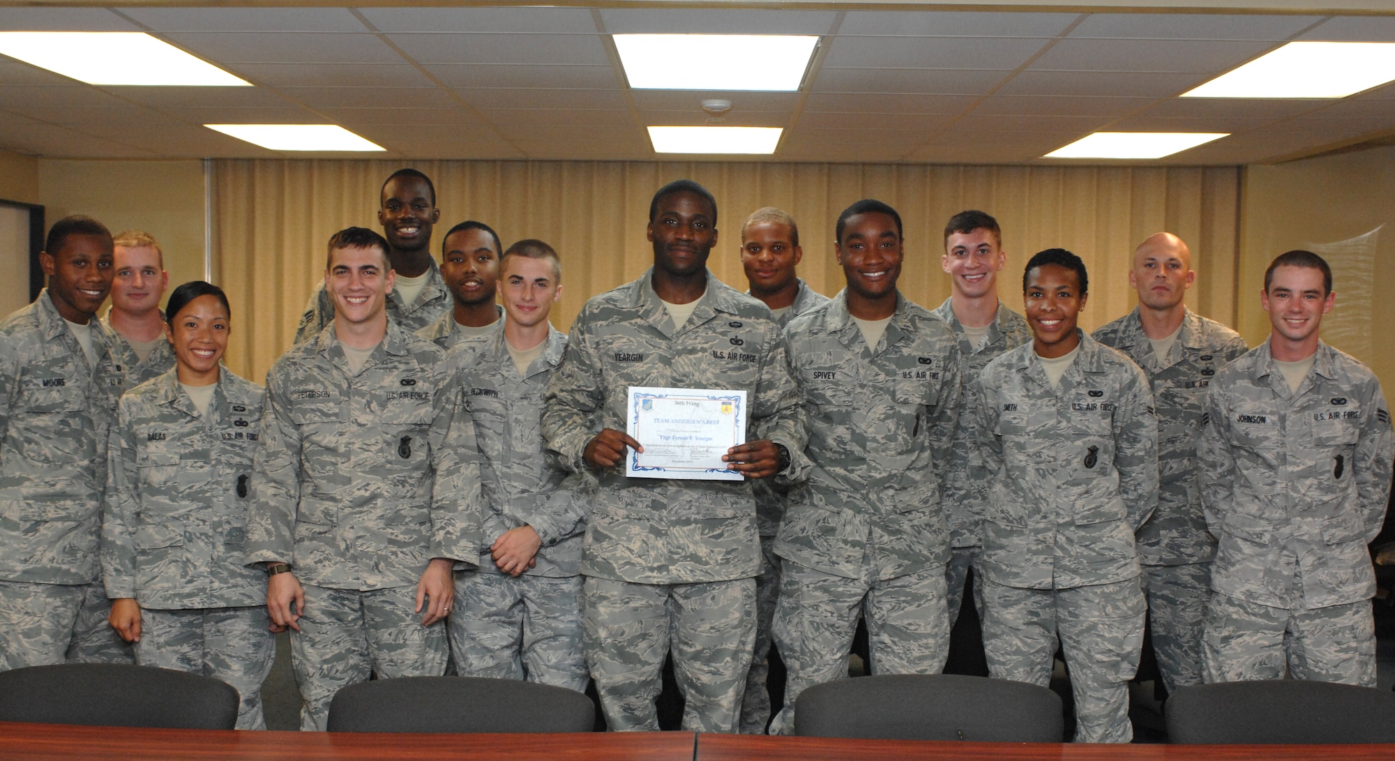 Tech. Sgt. Tyrone Yeargin (center), 736th Security Forces Squadron, stands with his coworkers after being awarded Andersen's Best here Dec. 28. Sergeant Yeargin was nominated for superior performance as NCO in charge of Operations. He supervises 24 expeditionary Airmen ensuring all are properly equipped and trained for United States Pacific Command contingencies, disaster response and humanitarian assistance missions. (U.S. Air Force photo/Staff Sgt. Jamie Powell)