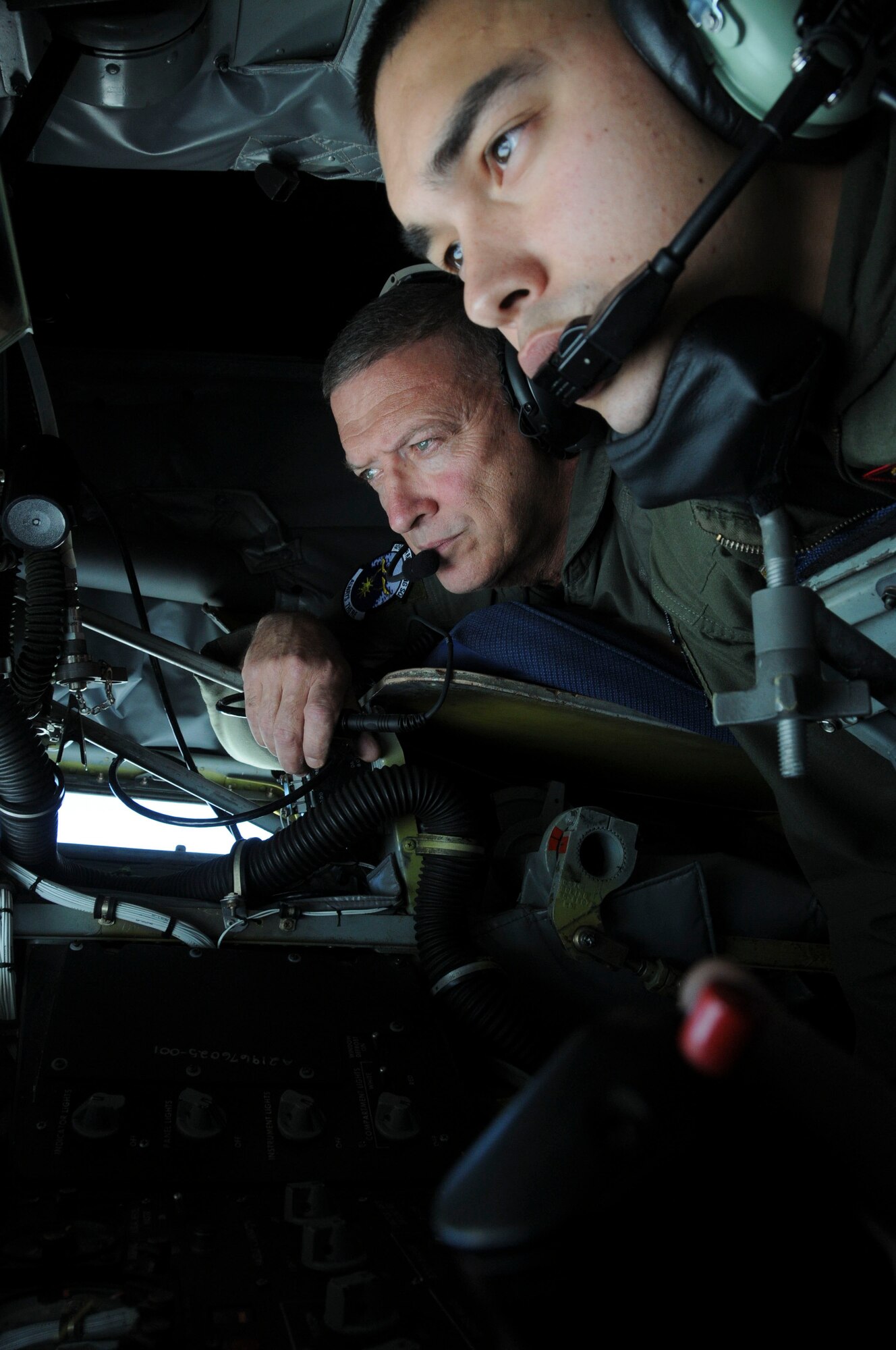 Gen. Gary North, Pacific Air Forces commander, watches as Senior Airman Jonathan Allessie, 909th Refueling Squadron boom operator, as he refuels an F-15 during his visit to Kadena Air Base Jan. 10. General North was shown the 909th's refueling capabilities when the squadron refueled both F-15s and AWACS aircraft. (U.S. Air Force photo/ Staff Sgt. Darnell T. Cannady)