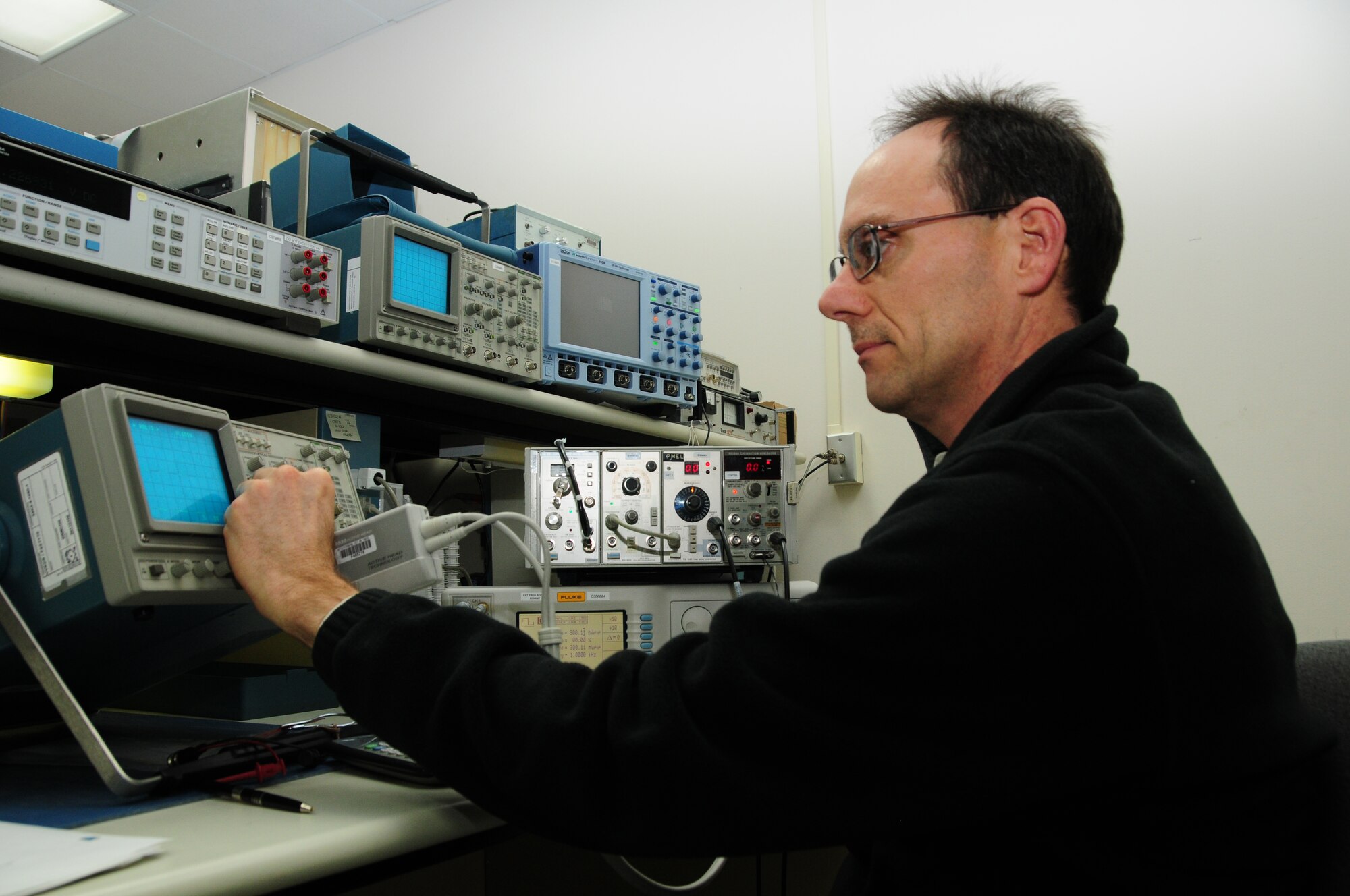 Michael Benko calibrates a digital oscilloscope while working in the Oscilloscope calibration area.  (U.S. Air Force photo by Master Sgt. Ralph J. Kapustka)  (Released)