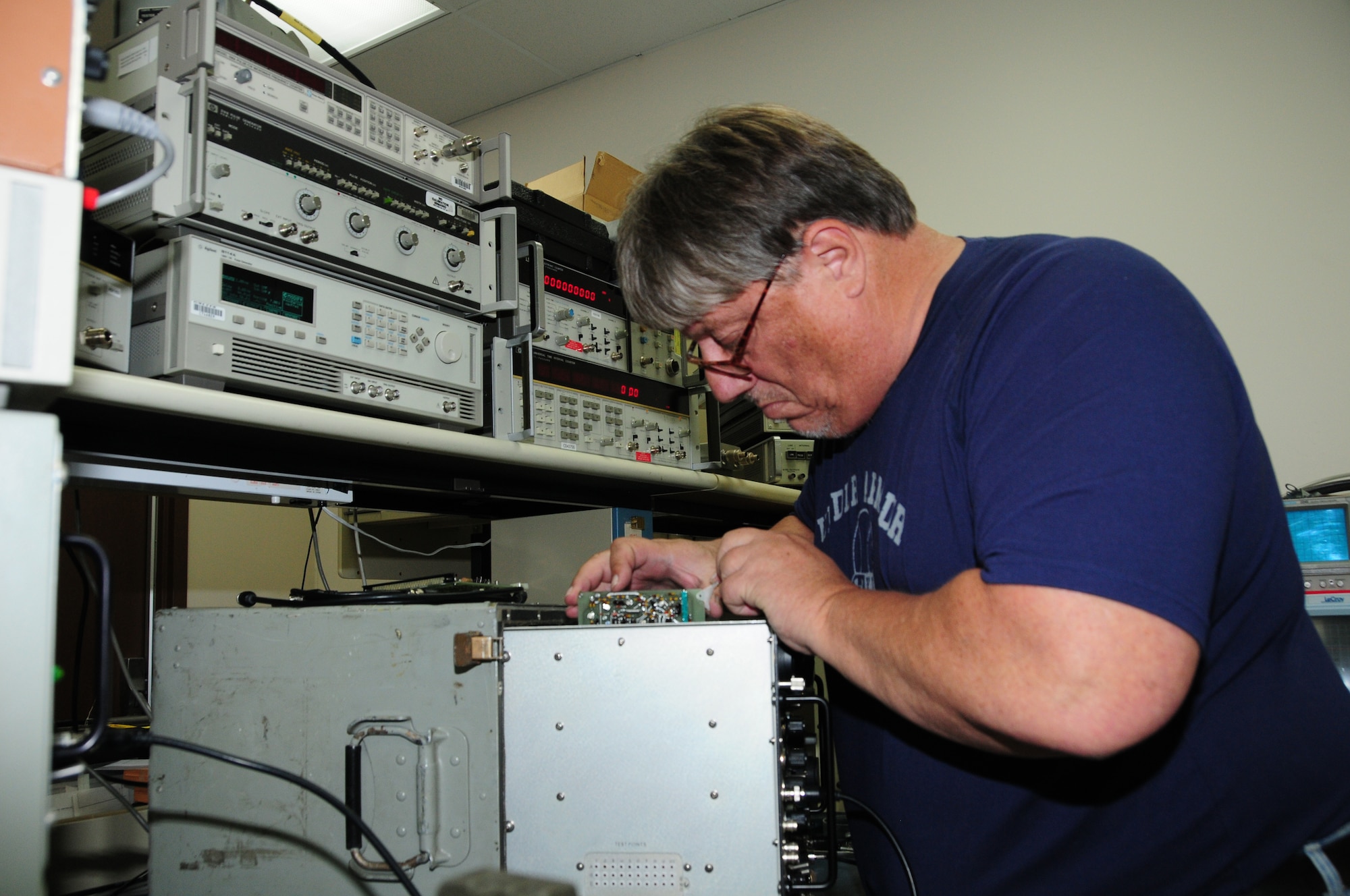 Jon Justin is troubleshooting a tactical air navigation test set while working in the Audio/Radio/Microwave Frequency calibration area.  (U.S. Air Force photo by Master Sgt. Ralph J. Kapustka)  (Released)
