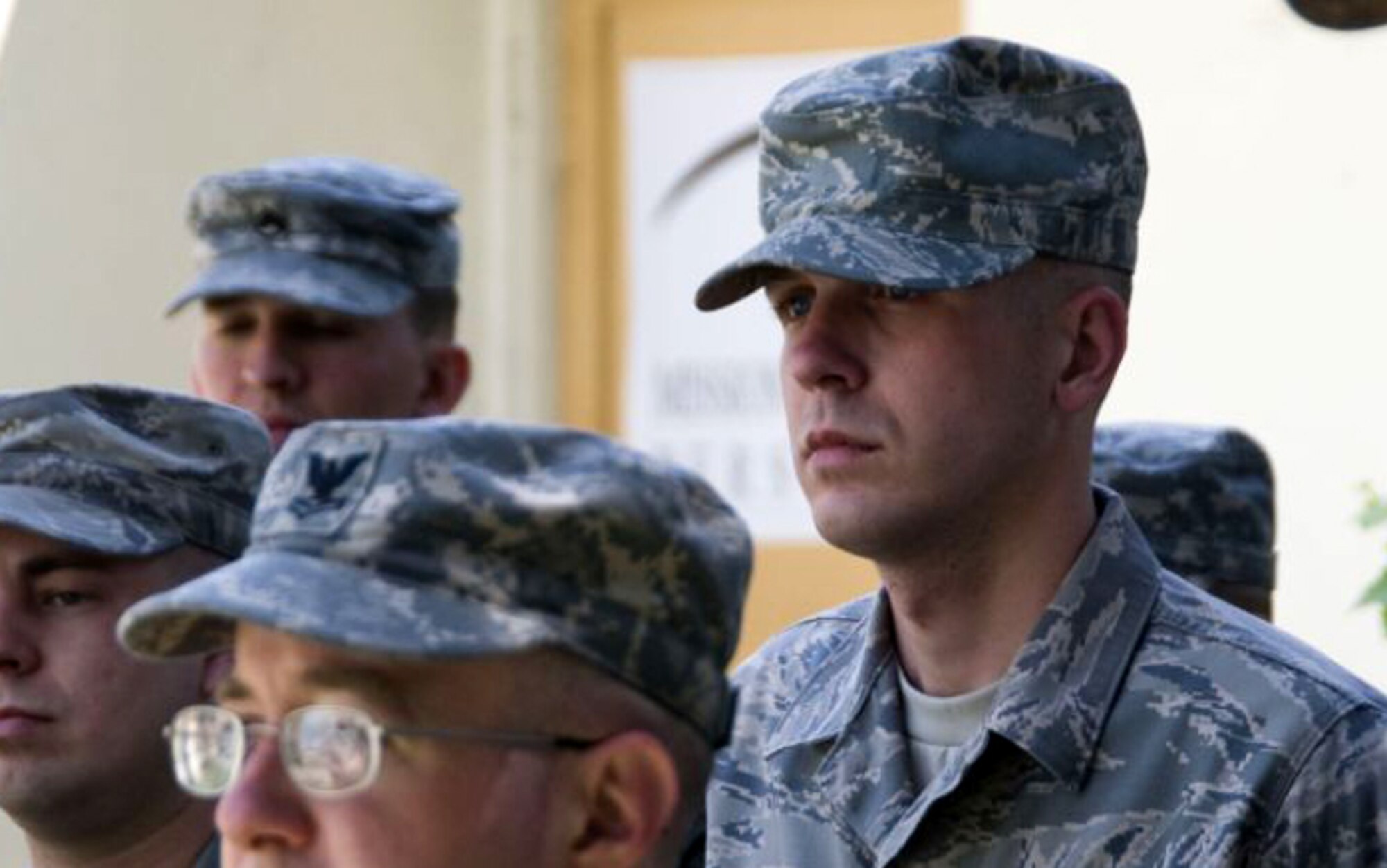 SOUTHWEST ASIA -- Senior Airman Dustin Chandler, Combined Security Transition Command-Afghanistan higher headquarters, awaits his name to be called at a commander's call during his deployment. Airman Chandler was recognized with the Unsung Heroes Award for effort in training Afghans and organizing the headquarters' supply shop. 