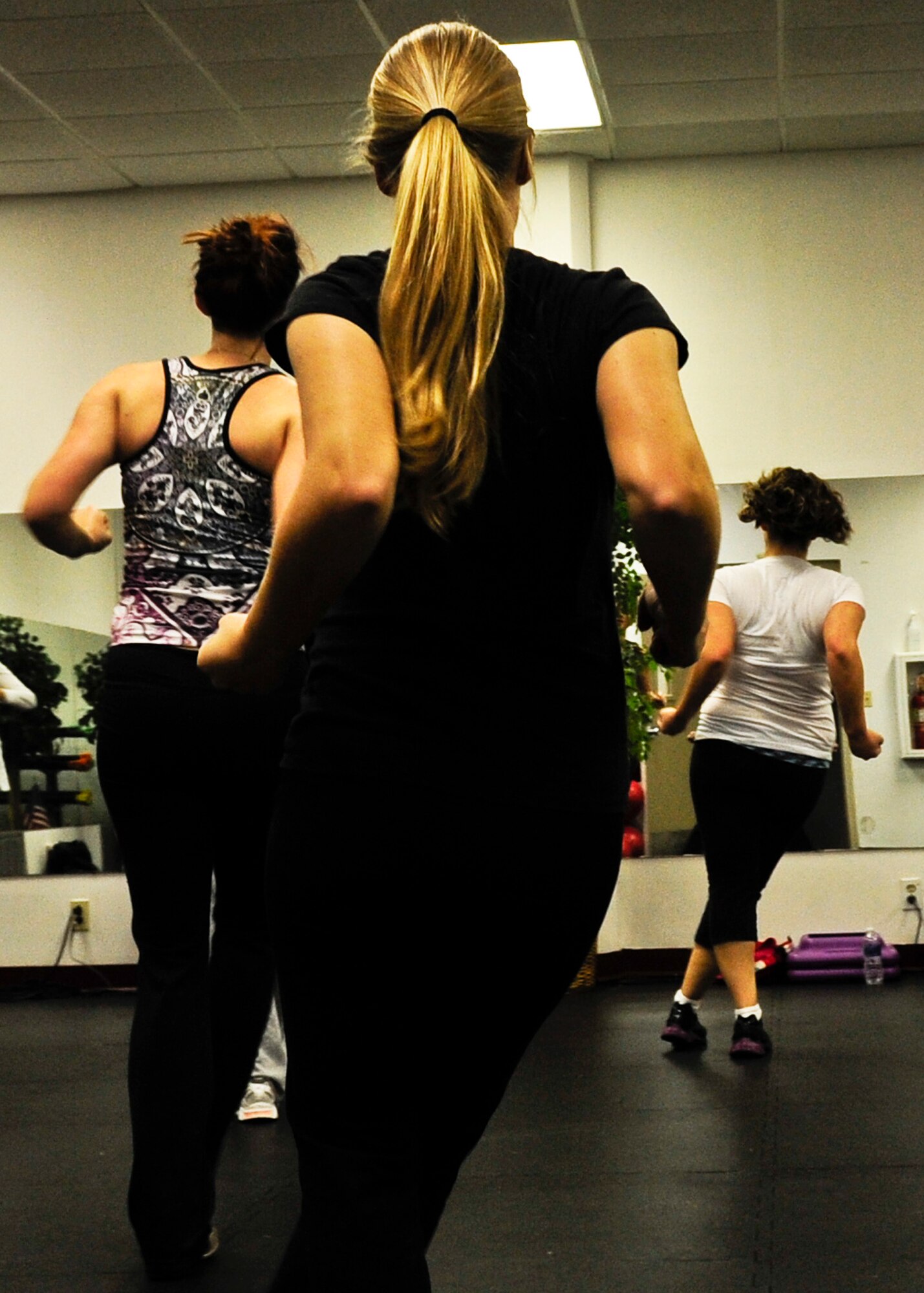 Feet stomping, hand clapping and hip shaking are just some of the Zumba moves.  Zumba is a fitness program that blends international music to various dance moves. Zumba is offered at the women’s field house Mondays and Fridays from 4:30-5:30 p.m. For more information, call the fitness annex at 883-2129. (U.S. Air Force photo/Sachel Seabrook)
