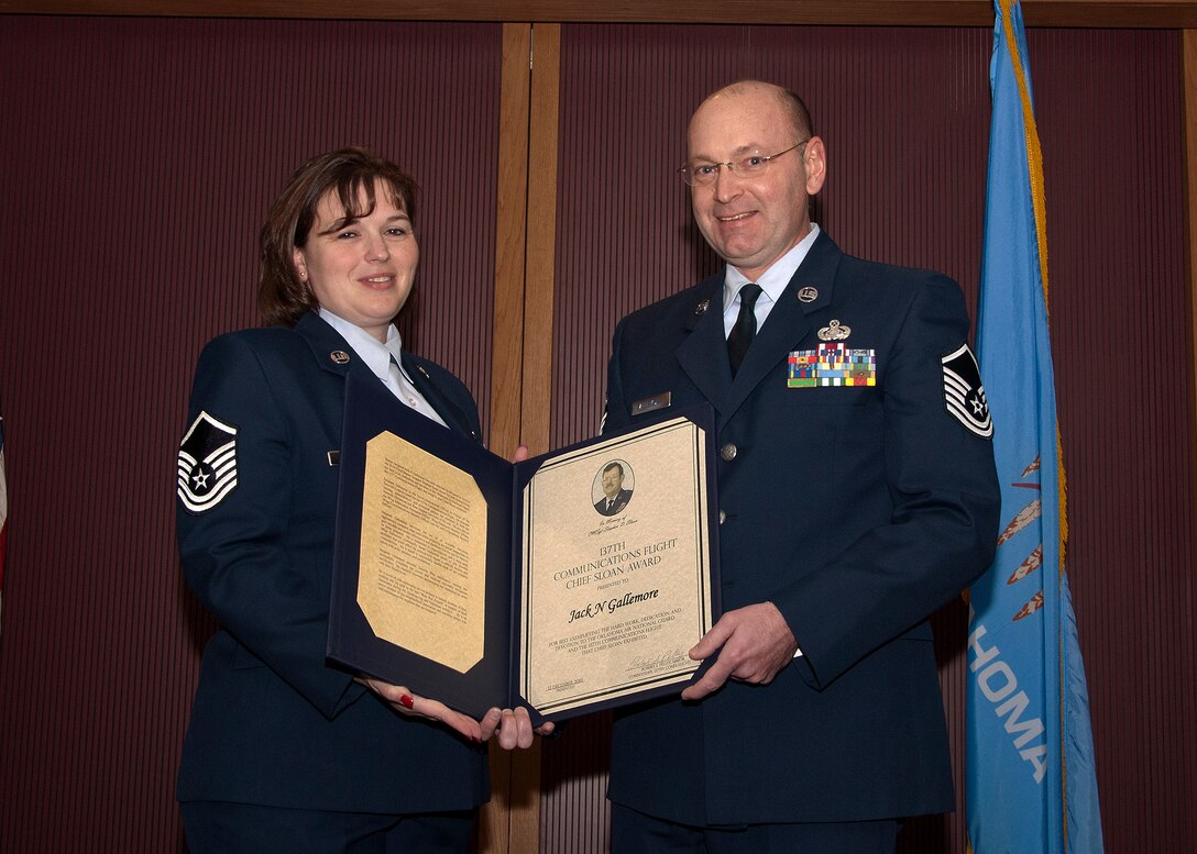 Master Sgt Leslie Sanchez presents Master Sgt Jack Gallemore, both members of 137th Communications Flight, with the Chief Sloan Award at an awards ceremony held Sunday, January 9, 2011, at Will Rogers Air National Guard Base, Okla.  The Chief Sloan Award is a 137th Communications Flight award given in memory of Chief Stephen D. Sloan and that recognizes exemplary performance and work ethic.  (USAF photo by Master Sgt Roberta Thompson)