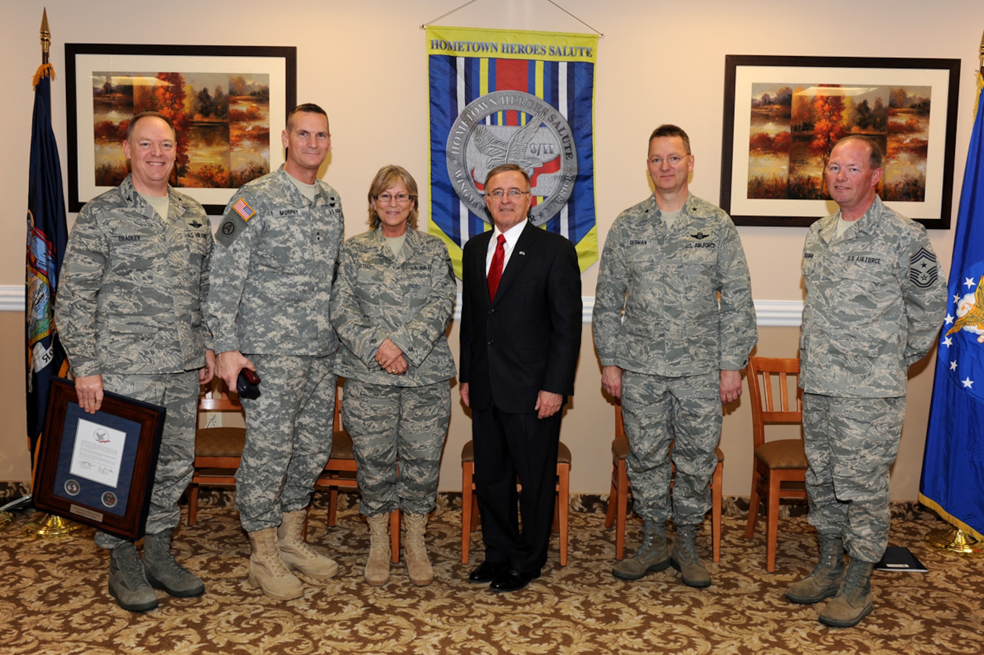 U.S. Air Force Master Sgt. Deborah Bitely (third from left) of the 152nd Air Operations Group receives a Hometown Hero award from New York Air National Guard leadership at the Maplewood Inn in Liverpool, NY on Jan. 9, 2011.  Bitely received the award for her service to her country following Sept. 11, 2001. (US Air Force photo by Staff Sgt. Jim Faso/Released)