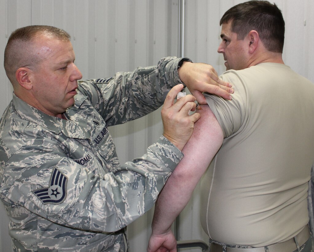 Staff Sgt. Steven Thomas administers the flu shot to Master Sgt. Michael O'Meara during the December UTA.  The 932nd Aerospace Medical Flight personnel visited units and work centers to ensure that all Wing members received the flu vaccine.  This year's vaccine helps fight the seasonal flu and the H1N1 strain.  (U.S. Air Force photo/Tech. Sgt. Dan Oliver) 