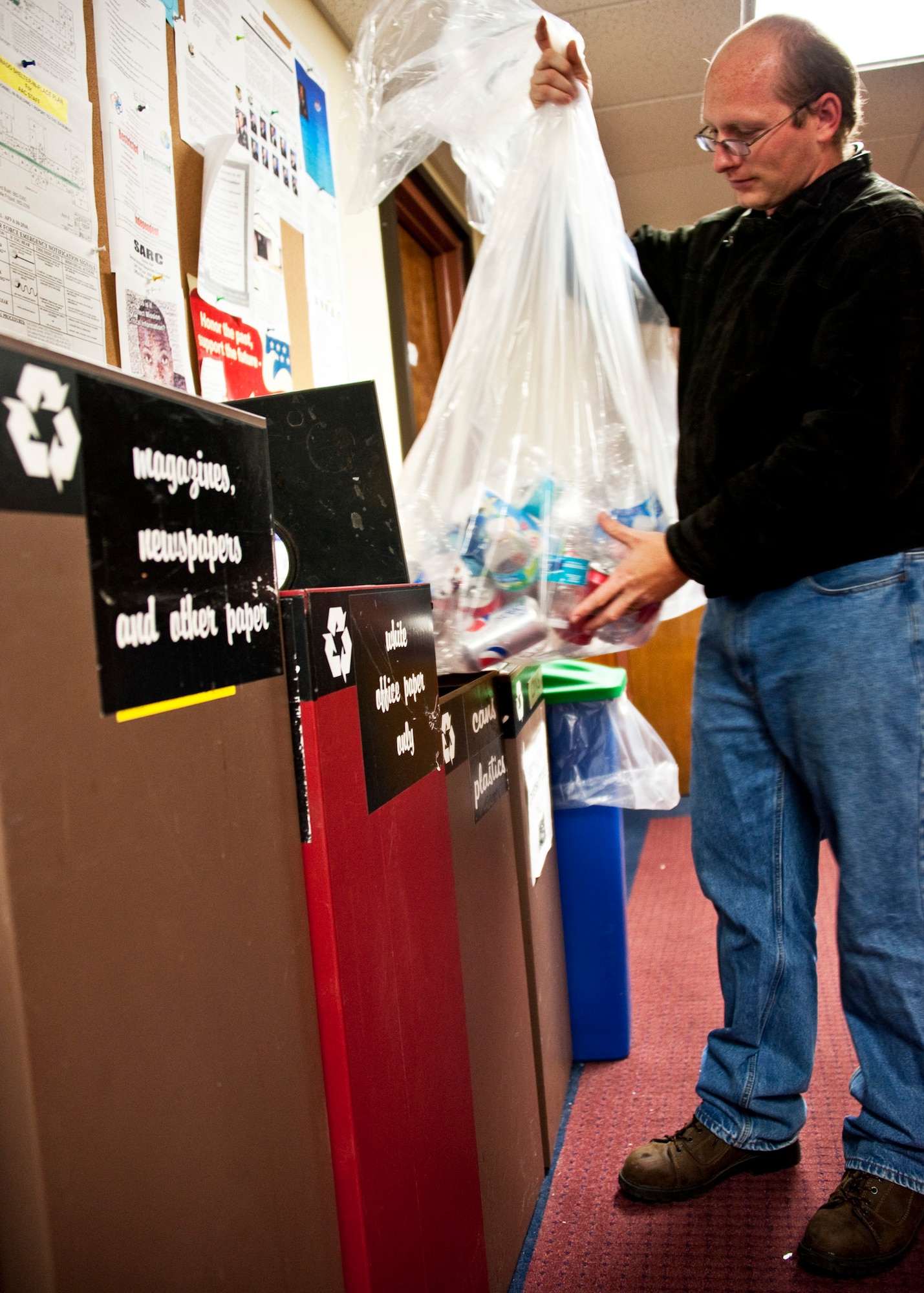 Chris Gearhart, an Eglin Recycle Center employee, empties the recyclable cans and bottles from a public square Jan. 11.  Now that Team Eglin members are disposing of their own trash, the recycle center wants to remind base personnel of all the items that can be recycled on base.  (U.S. Air Force photo/Samuel King Jr.)