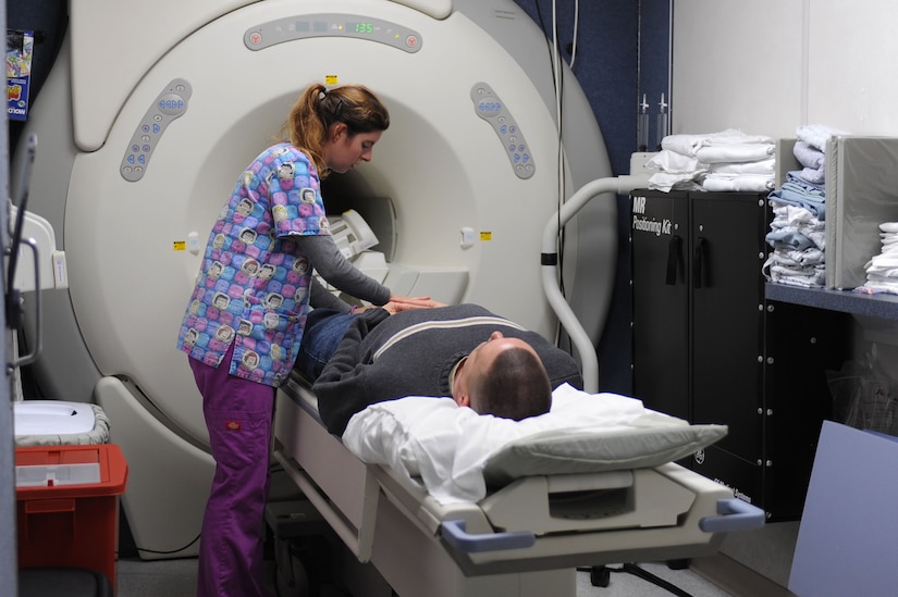 LANGLEY AIR FORCE BASE, Va. – Sarah Ivey, magnetic resonance imaging technician, prepares Chief Warrant Officer 3 Jeffrey Manninen, Army Logistics University instructor, for his scan Jan. 6 in the 633d Medical Group Radiology Department MRI trailer. With the addition of the MRI trailer, contracted with Alliance Imaging, patients can expect fewer delays in scheduling, appointment lengths and follow-up treatment. (U.S. Air Force photo/Senior Airman Brian Ybarbo)