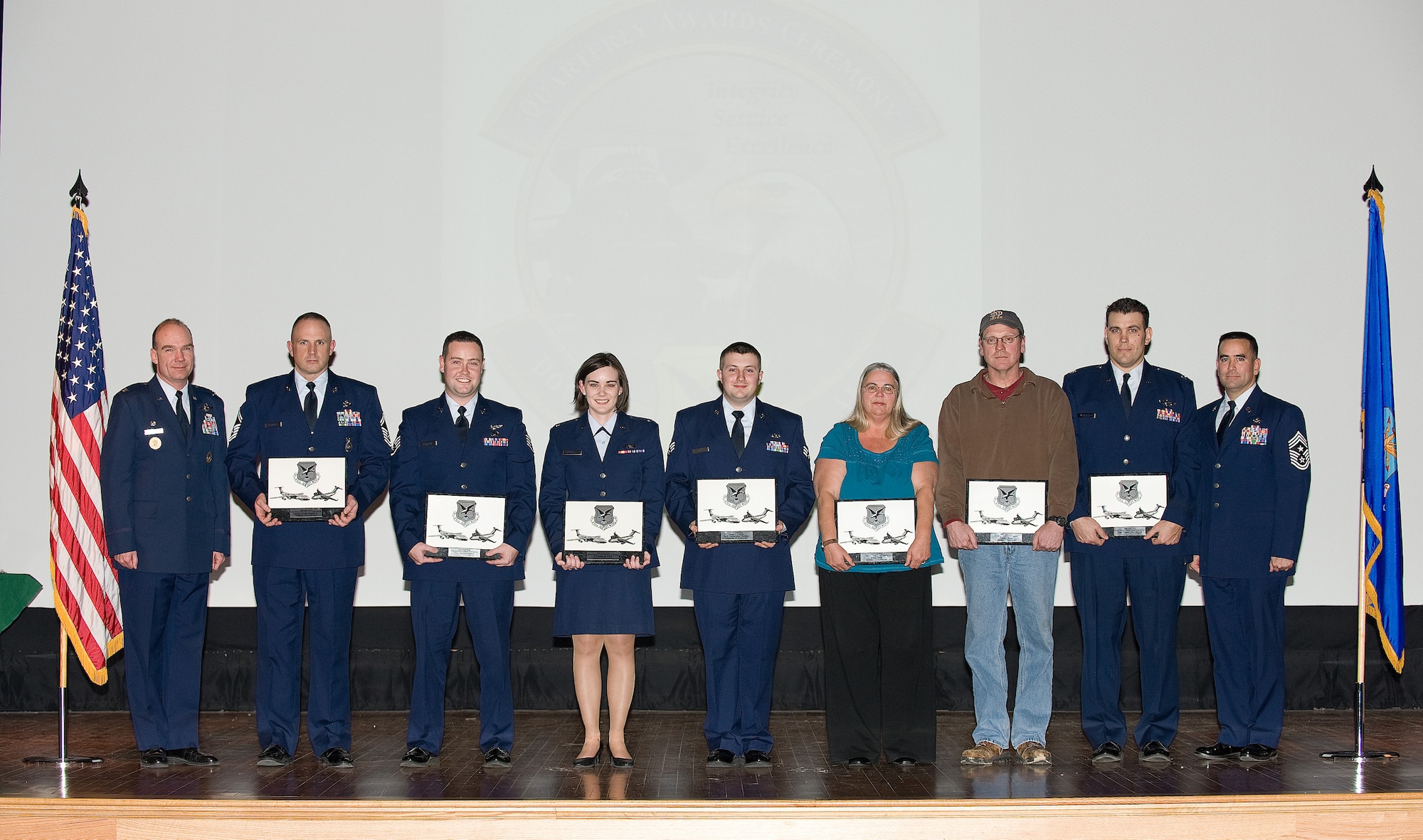 The winners of the Dover Air Force Base, Del., Wing Quarterly Awards come together for a photo Jan. 6, 2011. The winners of the Wing Quarterly Awards were Senior Airman Gary Stalcup, Best Dorm of the Quarter; Senior Airmen Jacqueline Shelton, Honor Guard Member of the Quarter; Anna Reed, Category One Civilian of the Quarter; Joseph Mika III, Category Two Civilian of the Quarter; Senior Airmen Christopher Shorkey, Airmen of the Quarter; Staff Sgt. Justin Leonard, Non-Commissioned Officer of the Quarter; Senior Master Sgt. Jerome Fenush, Senior NCO of the Quarter; 1st Lt. Amanda Elliot, Junior Company Grade Officer of the Quarter; and Capt. Patrick McClintock, Senior CGO of the Quarter. Team Dover Airmen and civilians are selected for the awards based on their skills and past achievements.  (U.S. Air Force photo by Jason Minto/Released)