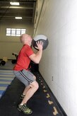Douglas Ryan performs "wall balls" which was one of three different exercises potential instructors had to perform during the CrossFit instructor course at the Fitness and Sports Center Jan. 5, 2011. The Fitness and Sports Center will hopefully be offering CrossFit classes towards the latter part of January for active duty military which are planned to be a 30-minute, high-intensity workout. Ryan is assigned to the 628th Civil Engineer Squadron as an explosive ordnance disposal technician. (U.S. Air Force photo/Staff Sgt. Marie Brown)