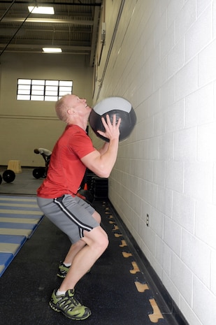 Douglas Ryan performs "wall balls" which was one of three different exercises potential instructors had to perform during the CrossFit instructor course at the Fitness and Sports Center Jan. 5, 2011. The Fitness and Sports Center will hopefully be offering CrossFit classes towards the latter part of January for active duty military which are planned to be a 30-minute, high-intensity workout. Ryan is assigned to the 628th Civil Engineer Squadron as an explosive ordnance disposal technician. (U.S. Air Force photo/Staff Sgt. Marie Brown)