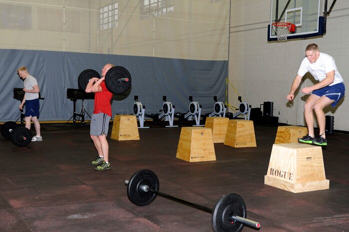 Joint Base Charleston members perform a timed routine consisting of three different exercises during the CrossFit instructor course at the Fitness and Sports Center Jan. 5, 2011. Members who attended the CrossFit instructor course performed three rounds of 20 repetitions of "box jumps", "wall balls" and "hang cleans" which consisted of 60 total repetitions per exercise, 180 for workout total. (U.S. Air Force photo/Staff Sgt. Marie Brown)
