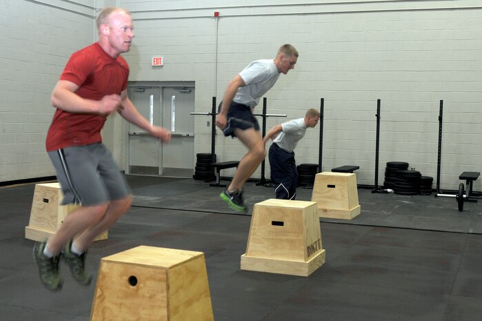 Joint Base Charleston members perform "box jumps" during the CrossFit instructor course at the Fitness and Sports Center Jan. 5, 2011. Members who attended the CrossFit instructor course went through a timed routine which consisted of performing three rounds of 20 repetitions of "box jumps", "wall balls" and "hang cleans". (U.S. Air Force photo/Staff Sgt. Marie Brown)
