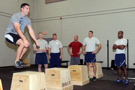 Steven Hart demonstrates how to perform "box jumps" which was one of three different exercises potential instructors had to perform during the CrossFit instructor course at the Fitness and Sports Center Jan. 5, 2011. The Fitness and Sports Center will hopefully be offering CrossFit classes towards the later part of January which are planned to be a 30-minute, high-intensity workout. Hart is the 628th Communications Squadron first sergeant. (U.S. Air Force photo/Staff Sgt. Marie Brown)
