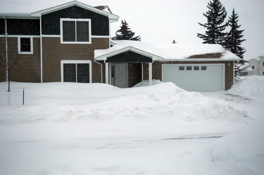 MINOT AIR FORCE BASE, N.D. -- Homes, sidewalks and streets throughout the Minot area, including these homes in Minot AFB base housing, are covered with snow all winter long and must be shoved regularly for safety and access.  Proper shoveling technique is necessary to avoid injury.  (U.S. Air Force photo/Senior Airman Sharida Jackson)