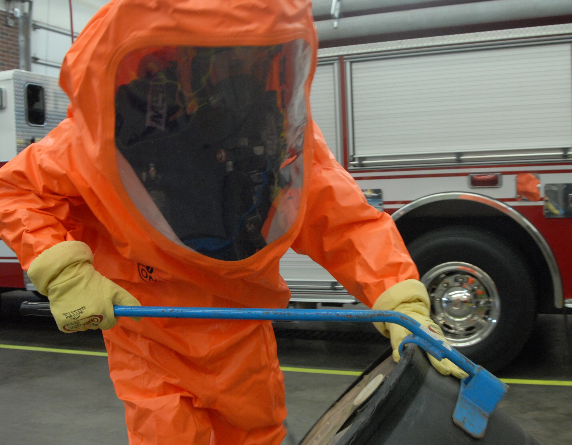 Justin Kammer, 17th Civil Engineer Squadron utilizes the drum tool to lift a 55 gallon drum during a demonstration Jan. 10. The new suits are cheaper, lighter, better quality and have a longer shelf life. (U.S. Air Force photo/Airman 1st Class Anne Gathua)