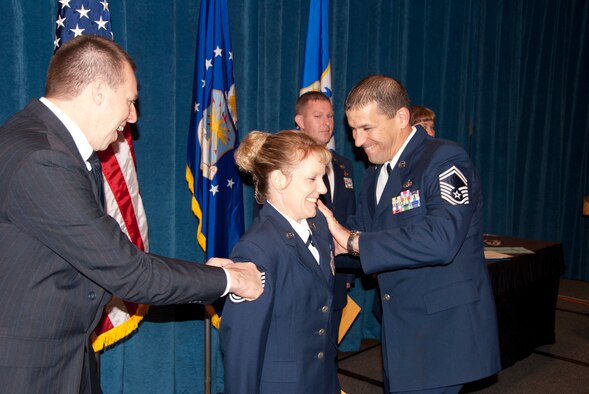 From left, Maj. Clarence K. "Kenny" Manus, Jr., commander of the 130th Force Support Squadron, 130th Airlift Wing, West Virginia Air National Guard, Charleston, W.Va. and Senior Master Sgt. John R. Ortiz, right, superintendant with the 130th FSS, pin stripes on Master Sgt. Theresa M. Curry, center, a personnel craftsman with the 130th FSS. Maser Sgt. Curry was one of three guardsmen from West Virginia promoted to the rank of master sergeant immediatelly following graduation from the NCO Academy at the I.G. Brown Air National Guard Training and Education Center, McGhee Tyson Air National Guard Base, Knoxville, Tenn., Nov. 16, 2010. (U.S. Air Force photo by Lt. Col. David G. Rabel)