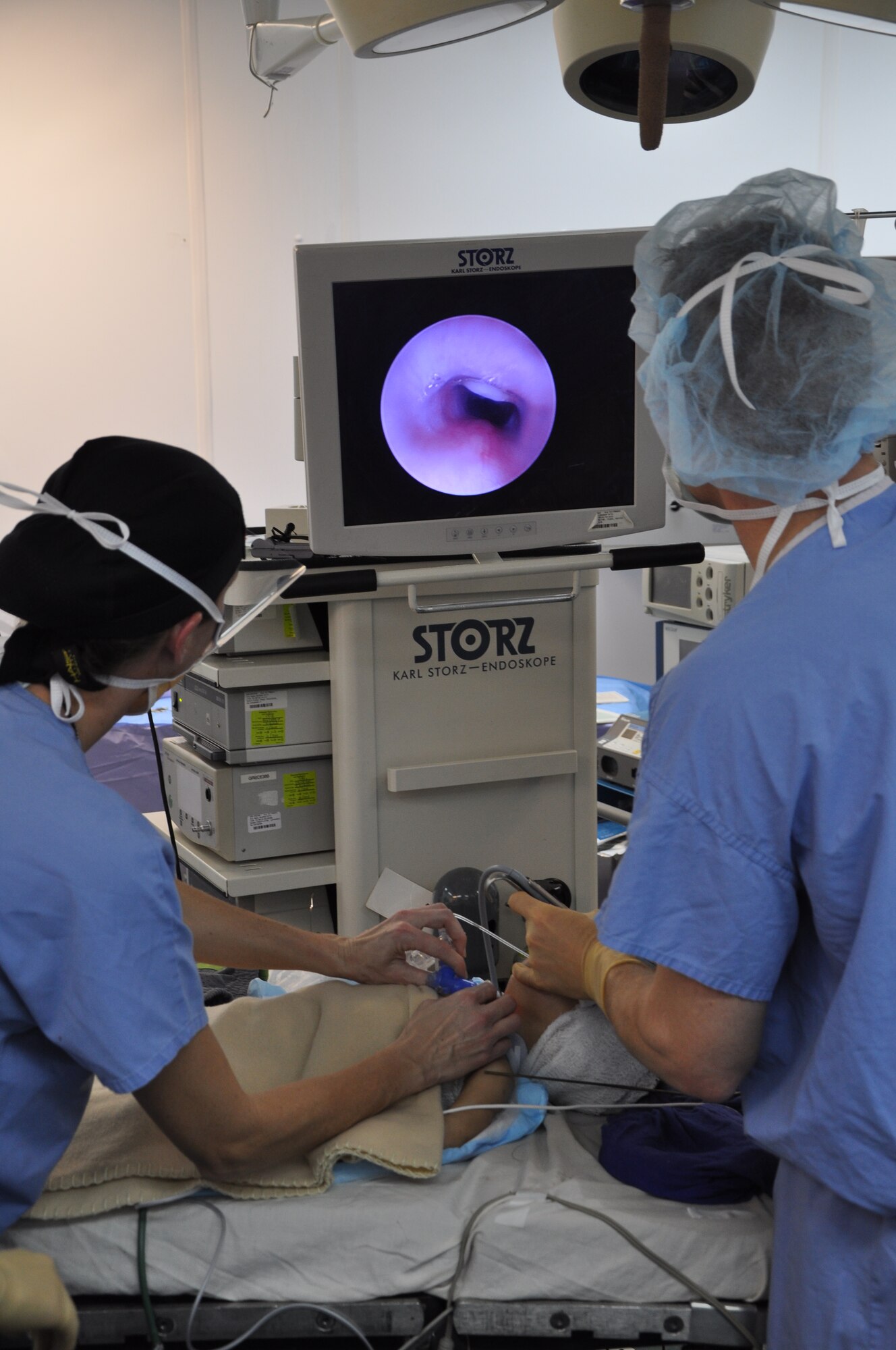 Craig Joint Theater Hospital medical team members use a bronchoscope to looking into the airway of a 12-month-old Afghan boy during a procedure in the operating room.  (U.S. Air Force photo by Capt. Erick Saks) 


