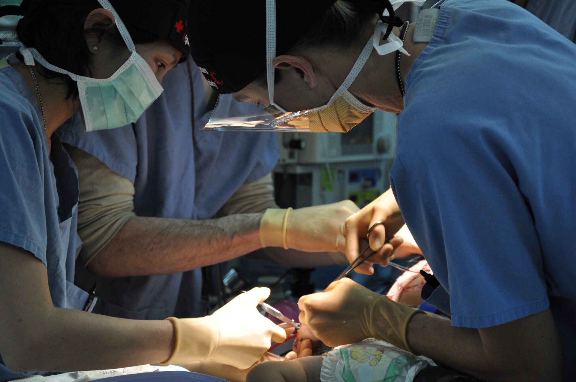 Craig Joint Theater Hospital medical personnel remove staples and dressings from a 12-month-old Afghan child who received significant burns from a propane tank explosion at his home in Kapisa Province.  (U.S. Air Force photo by Capt. Erick Saks)