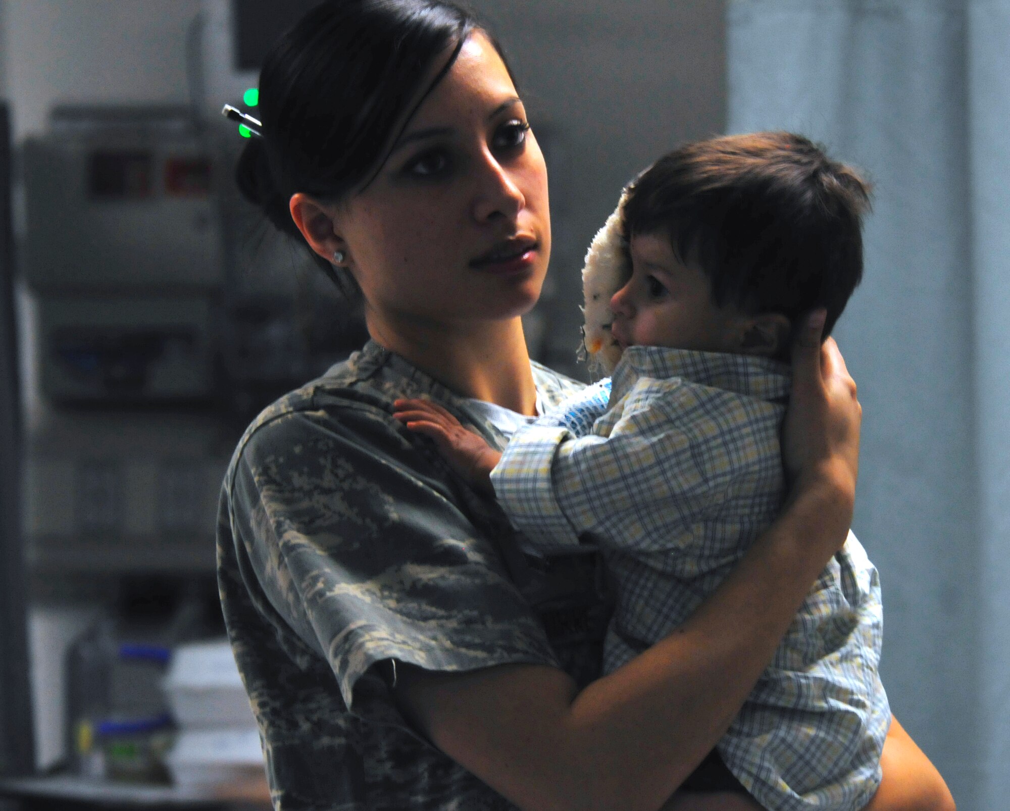 455th Expeditionary Medical Operation Squadron medical technican Senior Airmen Mabel Aguirre tends to Ajamal Hazrat a patient at the Craig Joint Theater Hospital at Bagram Airfield, Afghansitan, Jan. 10, 2011. Ajamal and a large majority of his family were badly injured after the propane tank used to heat their home exploded. Ajamal's grandfather and aunt were treated here and all three have touched the hearts of the doctors and medics who interact with them each day. (U.S. Air Force photo by Tech. Sgt. Michael Voss)  