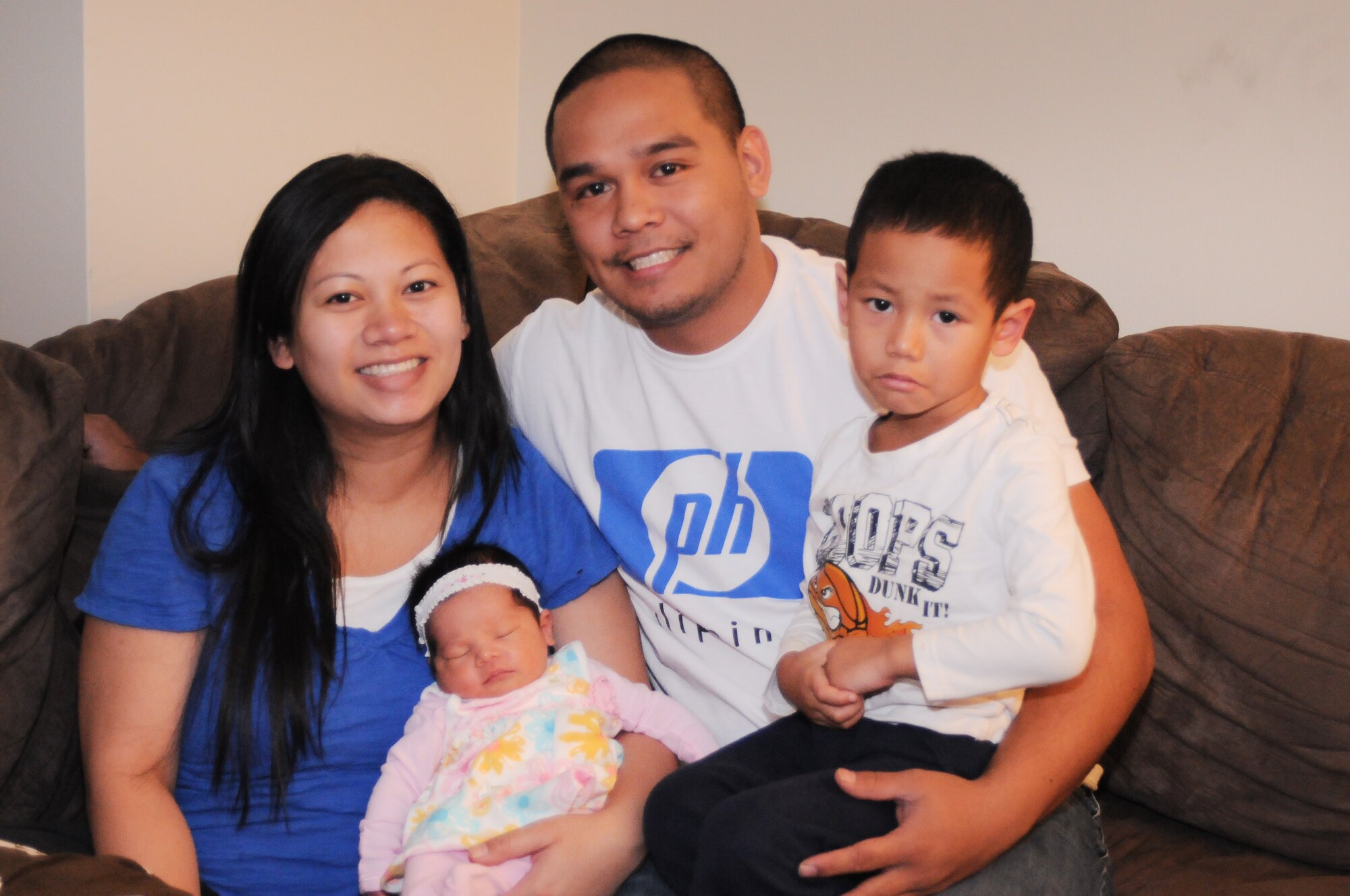 YOKOTA AIR BASE, Japan - Maria Archer, son Anfernee and husband, Staff Sgt. David Archer, surround the newest member of their family, Aaliyah Centron Archer, here Jan. 11. Aaliyah was the first baby born at Yokota's Base Hospital in 2011, arriving at 3:21 p.m. on Jan.3, and weighing 8 pounds, 4 ounces. Sergeant Archer is a Crew Chief assigned to the 374th Aircraft Maintenance Squadron. (U.S. Air Force photo/ Airman 1st Class Katrina R. Menchaca)