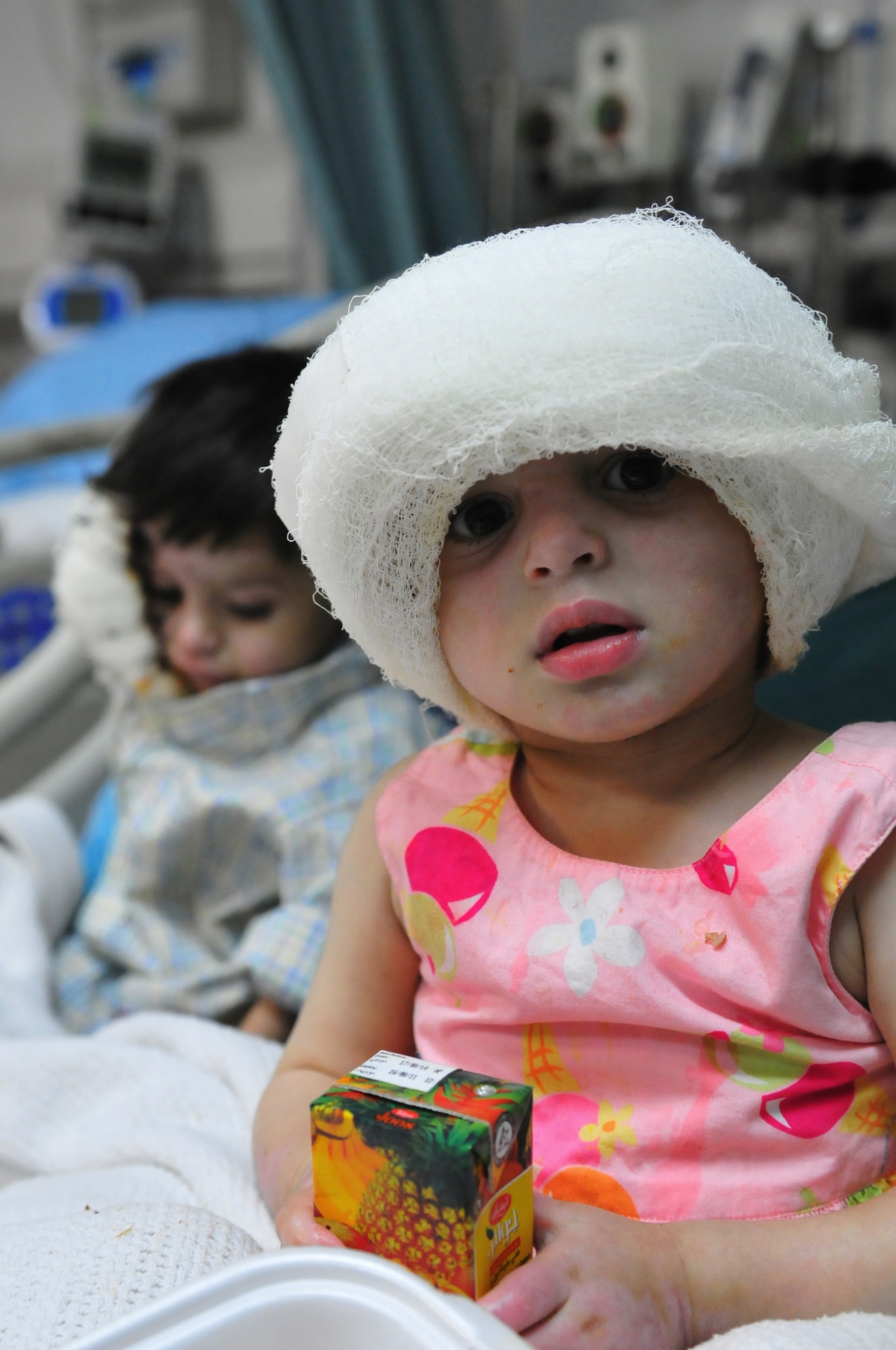 Satara Hazrat and her nephew Ajamal patients at the Craig Joint Theater Hospital enjoy some food and rest the night prior to their final surgeries, Jan. 10, 2011. A large majority of the Hazrat family were badly injured after the propane tank used to heat their home exploded. During the time they were treated here they have touched the hearts of many doctors and medics who interact with them each day. (U.S. Air Force photo by Tech. Sgt. Michael Voss)  