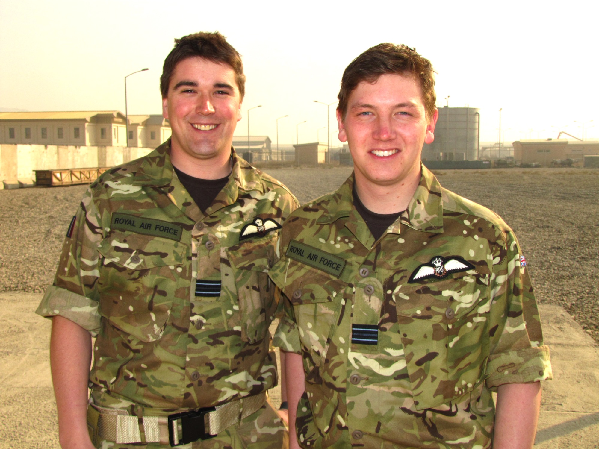 Royal Air Force Flight Lieutenants John Parry and Dean Curt pose for a photograph on the porch of the Thunder Lab English immersion program at the Afghan Air Force Base in Kabul, Afghanistan. Parry and Curt are the second set of RAF pilots to enter the Thunder Lab program in hopes of helping Afghan lieutenants improve their English comprehension as they prepare as future pilots and officers in the Afghan Air Force. (Photo by Mass Communications Specialist 2nd Class Vladimir Potapenko/RELEASED)