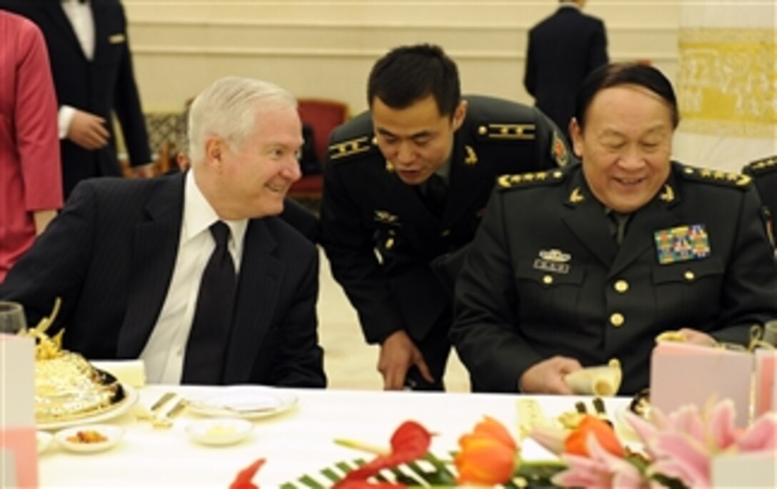 Secretary of Defense Robert M. Gates and Chinese Minister of Defense Liang Guanglie talk with each other at a luncheon honoring Gates' visit to Beijing, China, on Jan. 10, 2011.  