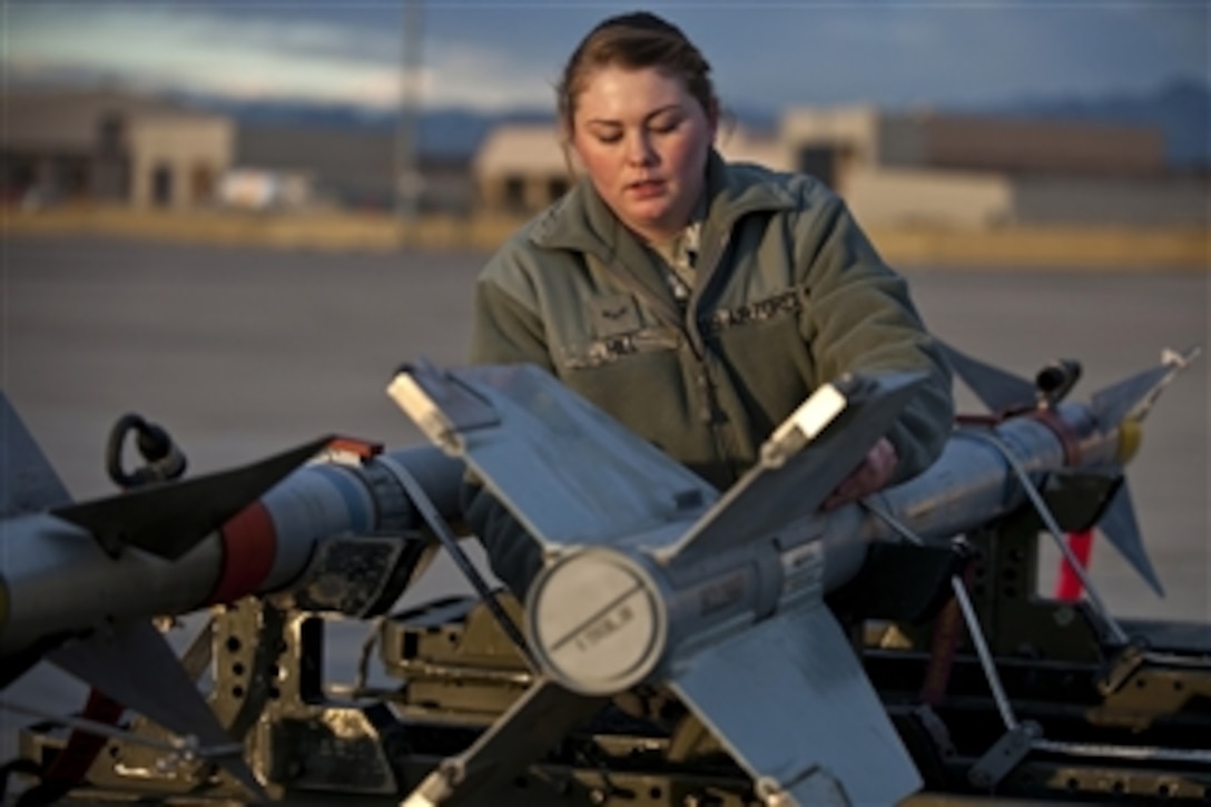 U.S. Air Force Airman 1st Class Ashley Hill, an aircraft armament systems apprentice with the 57th Aircraft Maintenance Squadron, conducts preload checks on an AIM-9 air-to-air missile during a weapons load competition at Nellis Air Force Base, Nev., on Jan. 7, 2011.  Officials evaluated airmen on checklist use, safety and overall speed.  