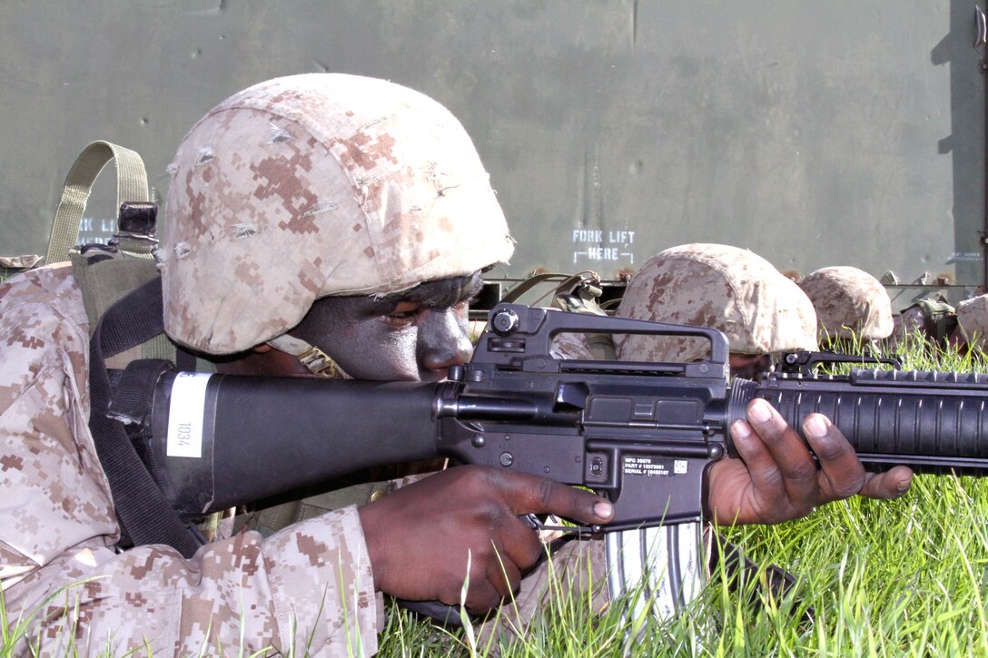 Recruit Murad F. Eiland, Platoon 1034, Company B, 1st Recruit Training Battalion, provides security alongside other recruits, after making it over an obstacle. Having recruits provide security during training exercises better helps them understand the importance of providing cover for fellow Marines.