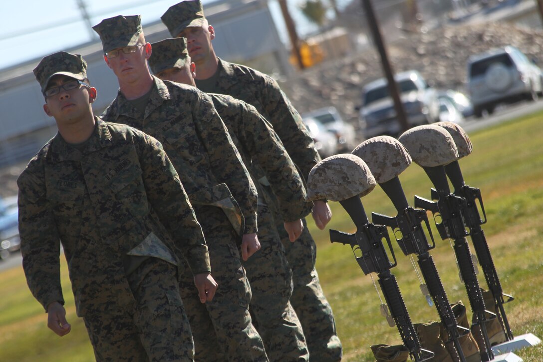 Marines with 3rd Combat Engineer Battalion, stationed here, march off after placing boots on the battlefield crosses of four Marines with the battalion who were killed in action during the unit’s last deployment in support of Operation Enduring Freedom in 2010. The ceremony took place at the Combat Center’s Lance Cpl. Torrey L. Gray Field Jan. 12, 2011.