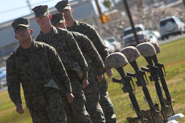 Marines with 3rd Combat Engineer Battalion, stationed here, march off after placing boots on the battlefield crosses of four Marines with the battalion who were killed in action during the unit’s last deployment in support of Operation Enduring Freedom in 2010. The ceremony took place at the Combat Center’s Lance Cpl. Torrey L. Gray Field Jan. 12, 2011.