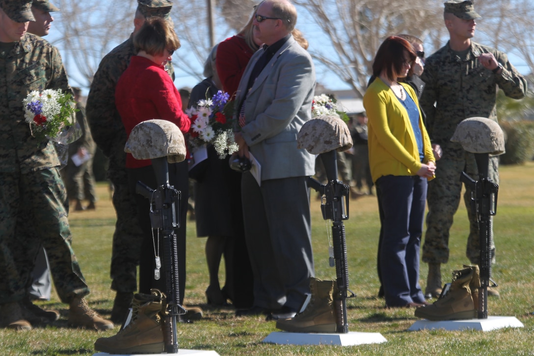Family members and Marines view the battlefield crosses of four Marines from 3rd Combat Engineer Battalion, who were killed in support of Operation Enduring Freedom in 2010. The memorial service was held at the Combat Center’s Lance Cpl. Torrey L. Gray Field Jan. 12, 2011.