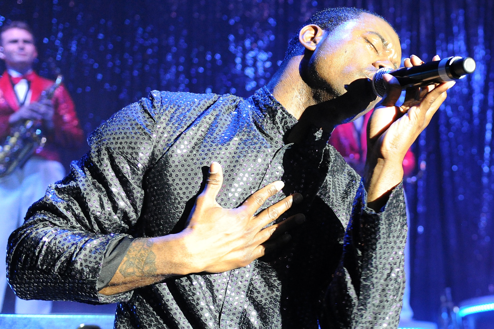 KUNSAN AIR BASE, Republic of Korea--Capt. John Early sings for the crowd during a Tops in Blue performance Jan. 11. The Tops in Blue group performed their 2010 "We Believe" World Tour for the base Jan. 11-12. The performance included renditions of songs from artists including Michael Buble, Lady Gaga, and the Black Eyed Peas. (U.S. Air Force photo/Staff Sgt. Jonathan Pomeroy) 