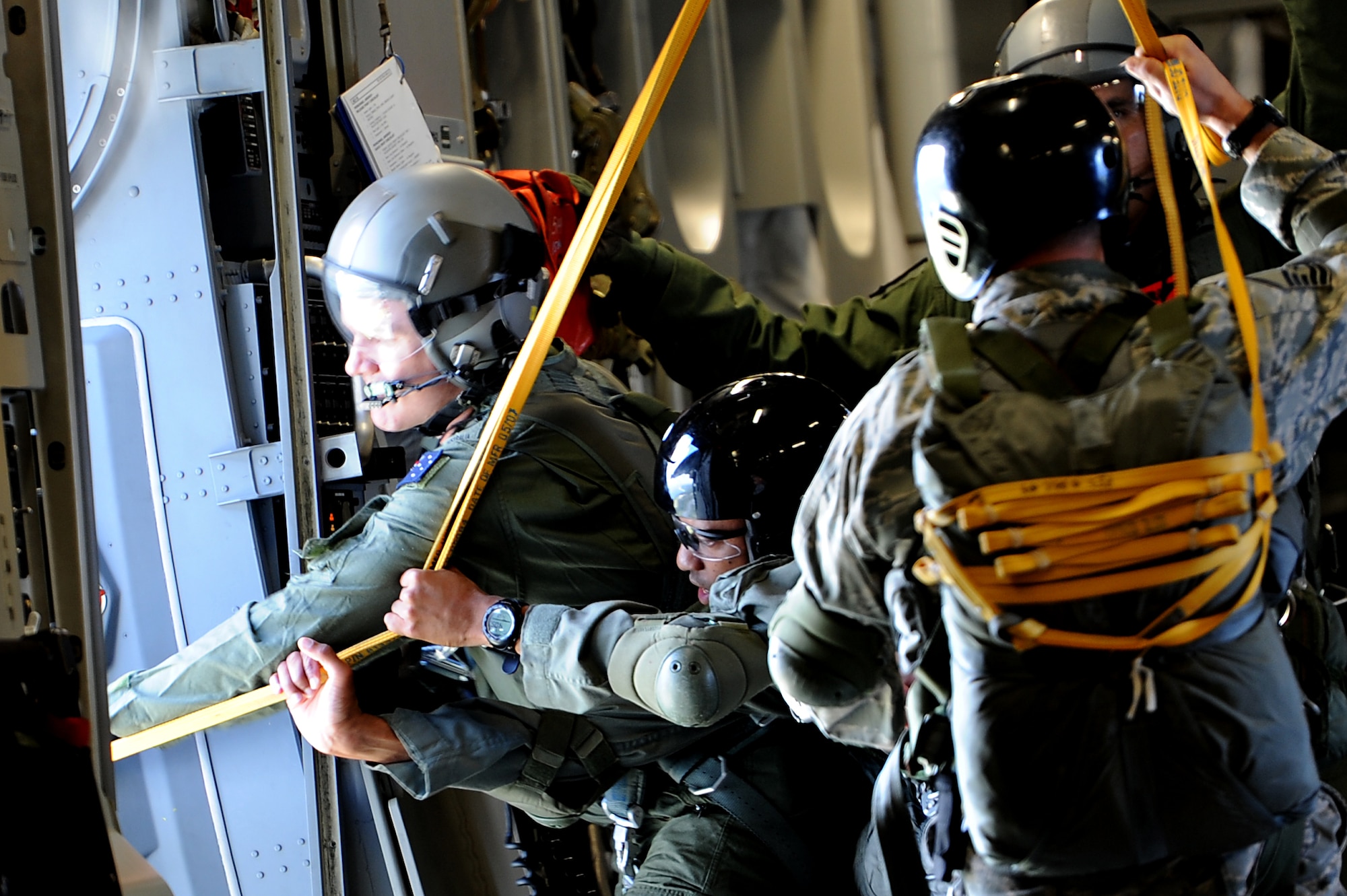 Members of the 36th Contingency Response Group conduct static line jump training from a Hickam C-17 over Andersen Air Base, Guam, Jan. 11. Aircrews from the 535th Airlift Squadron dropped nine training pallets during a single day of training before prviding airlift for the 36th CRG jumpers. (U.S. Air Force photo/Staff Sgt. Mike Meares)