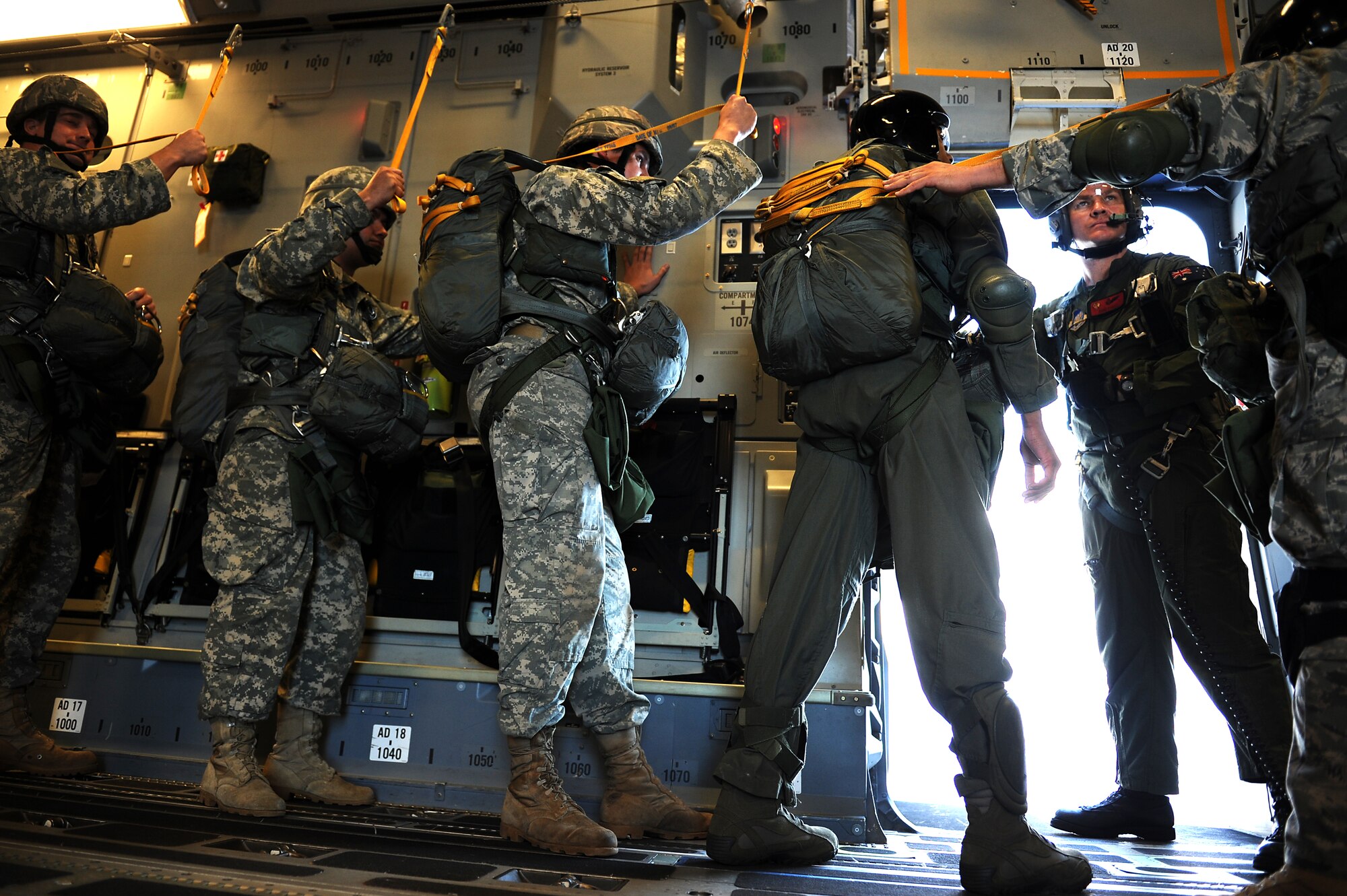 Members of the 36th Contingency Response Group conduct static line jump training from a Hickam C-17 over Andersen Air Base, Guam, Jan. 11. Aircrews from the 535th Airlift Squadron dropped nine training pallets during a single day of training before prviding airlift for the 36th CRG jumpers. (U.S. Air Force photo/Staff Sgt. Mike Meares)