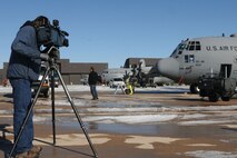 A cameraman with KOAA, NBC affiliate, takes footage of aircraft used in three of the Air Force Reserve Command's special missions, which include weather reconnaissance, aerial spray and aerial firefighting. Airmen and aircraft from the 302nd Airlift Wing here, the 403rd Wing, Keesler Air Force Base, Miss., and the 910th Airlift Wing, Youngstown Air Reserve Base, Ohio, convened at Peterson AFB for AFRC's first ever C-130 Special Missions conference Jan. 12-13. The conference is designed to share lessons learned, policies and procedures and tackle common support and wing issues. (U.S. Air Force photo/Tech. Sgt. Daniel Butterfield)