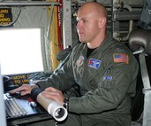 Master Sgt. Edward Scherzer, 53d Weather Reconnaissance Squadron loadmaster, demonstrates how he prepares a dropsonde for launch into a hurricane. The dropsonde gathers barametric pressure, temperature, humidity, wind speed and direction, which helps weather forcasters better predict weather models. The demonstration was part of the Air Force Reserve Command's first ever C-130 Special Mission Conference at Peterson Air Force Base, Colo., Jan. 12-13, 2010. (U.S. Air Force photo/Capt. Marnee A.C. Losurdo)