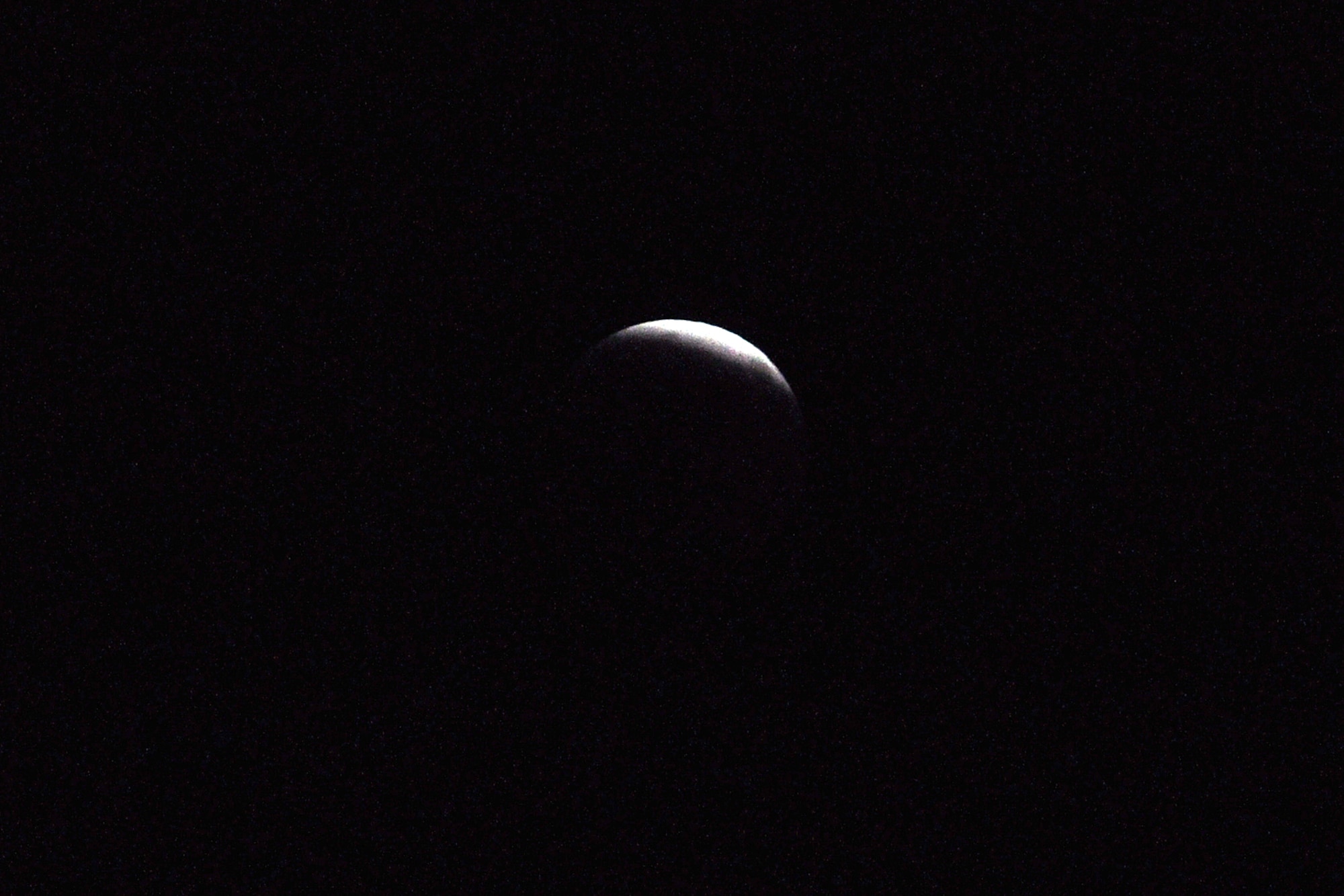Only a small sliver of moon still reflects sunlight as the earth's shadow overtakes the orb at 10:37 p.m. (U.S. Air Force photo/John Pennell)