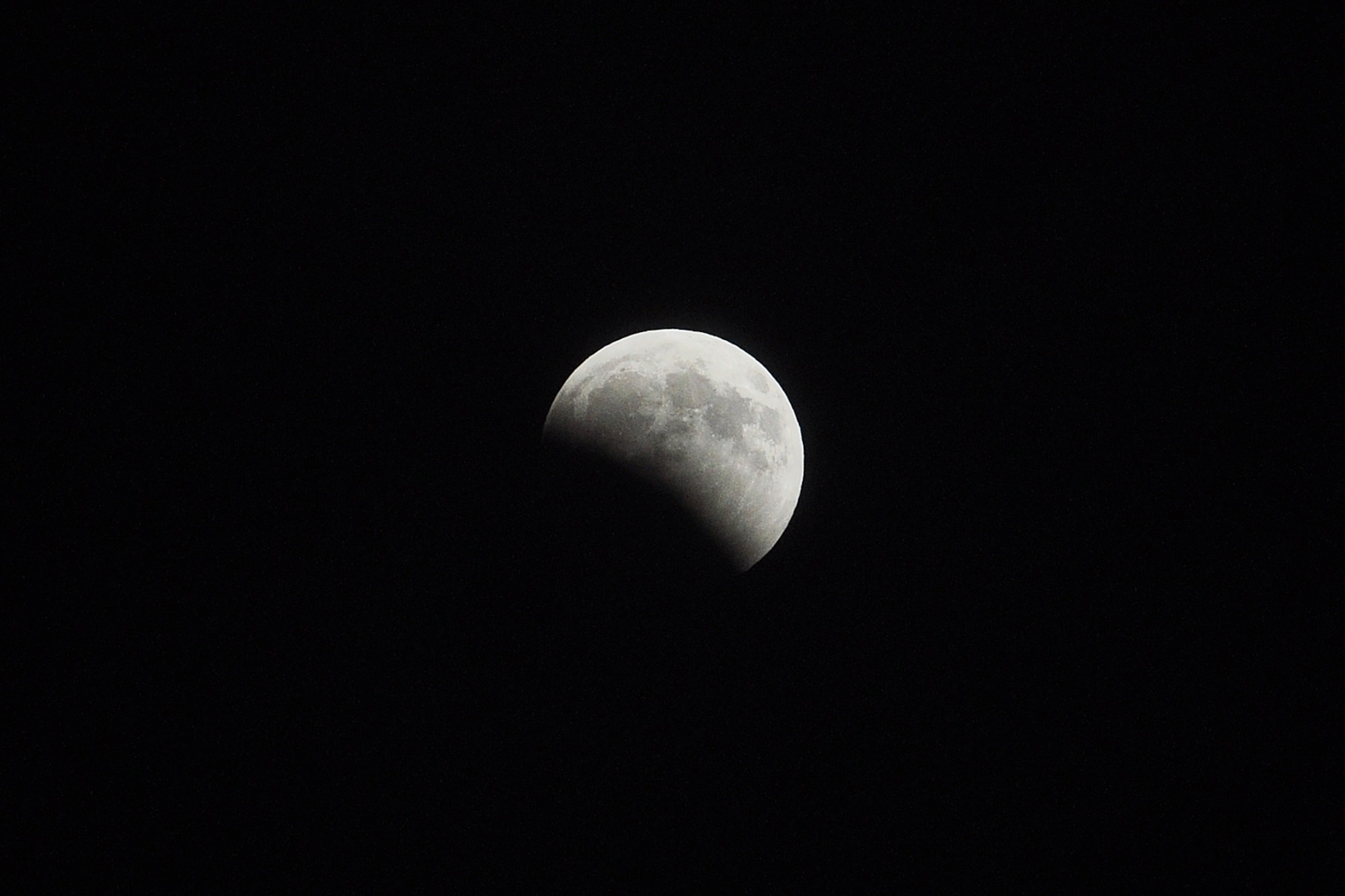 By 10:01 p.m. the moon is almost half covered by the earth's shadow. (U.S. Air Force photo/John Pennell)