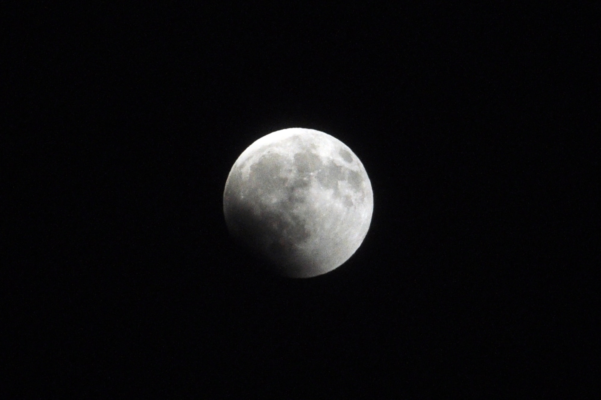 The effects of the earth's shadow can be seen at 9:39 p.m.  (U.S. Air Force photo/John Pennell)