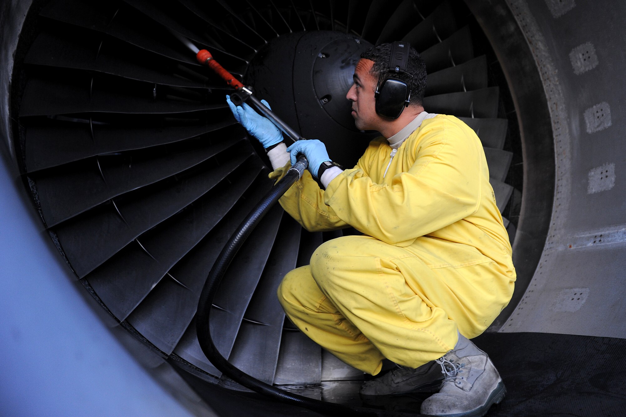 Staff Sgt. Luis Mejias, 15th Aircraft Maintenance Squadron, inspects and washes the blades of a C-17 Globemaster III from Joint BAse Pearl Harbor-Hickam, Hawaii Jan. 9. Aircrews from the 535th AS dropped nine training pallets during a single day of training while on temporary assignment to Andersen Air Base, Guam. The aircrew then helped the 36th CRG with static line jump training. (U.S. Air Force photo/Staff Sgt. Mike Meares)