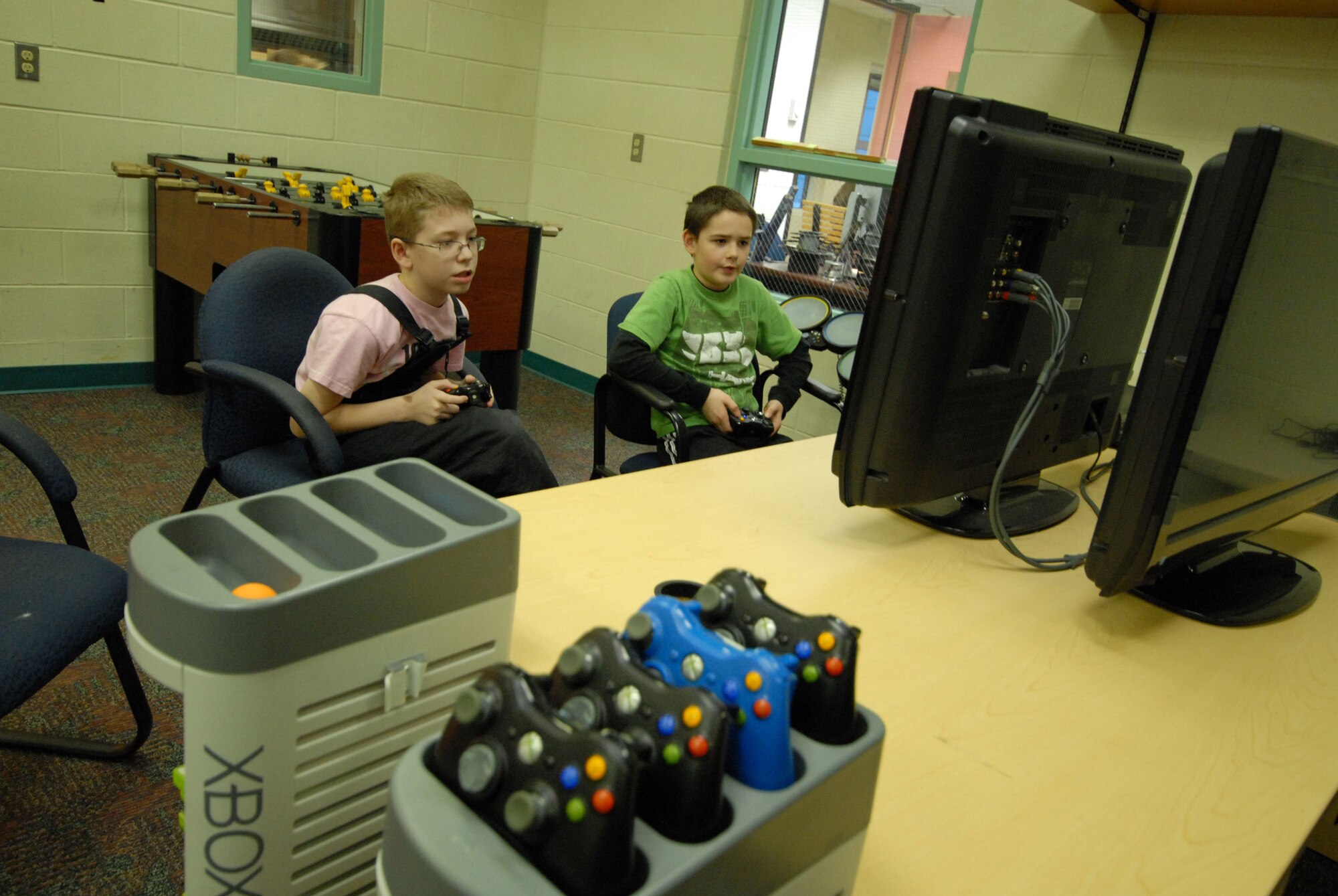 Gavin Bell and Meo Poyeur, both 10 years old, enjoy a video game, Jan. 11, at the Two Rivers Youth Center.  (U.S. Air Force photo/Steve White)