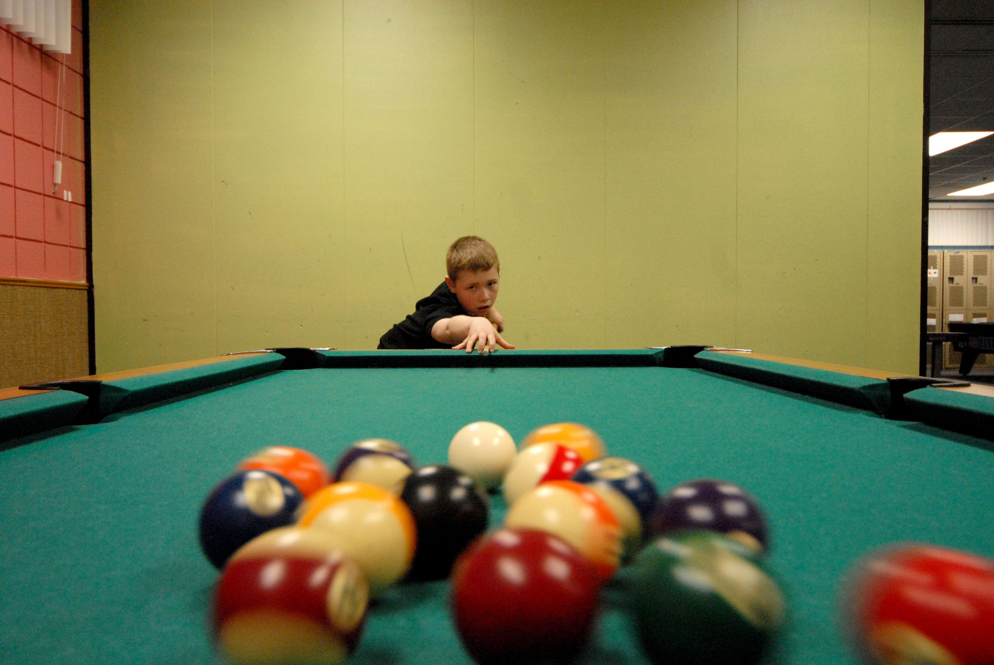 James Fitzgerald practices his break shot before a pool tournament at the Kennecott Youth Center. (U.S. Air Force photo/Steve White)