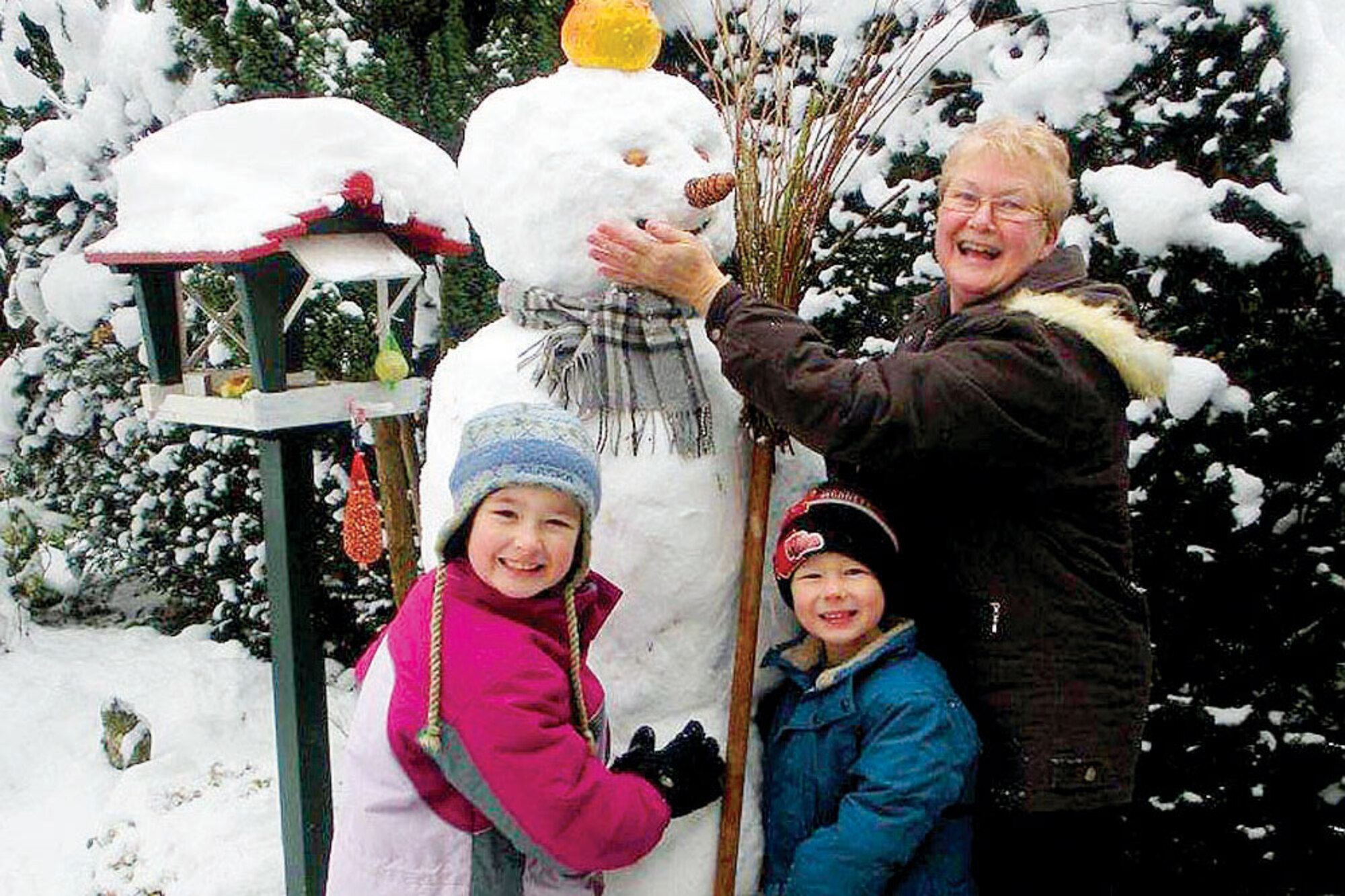 Naomi and Ryan Ornelles make a snowman with their grandmother, Alie Wierdsma, in Doorn, Netherlands. (Courtesy photo)
